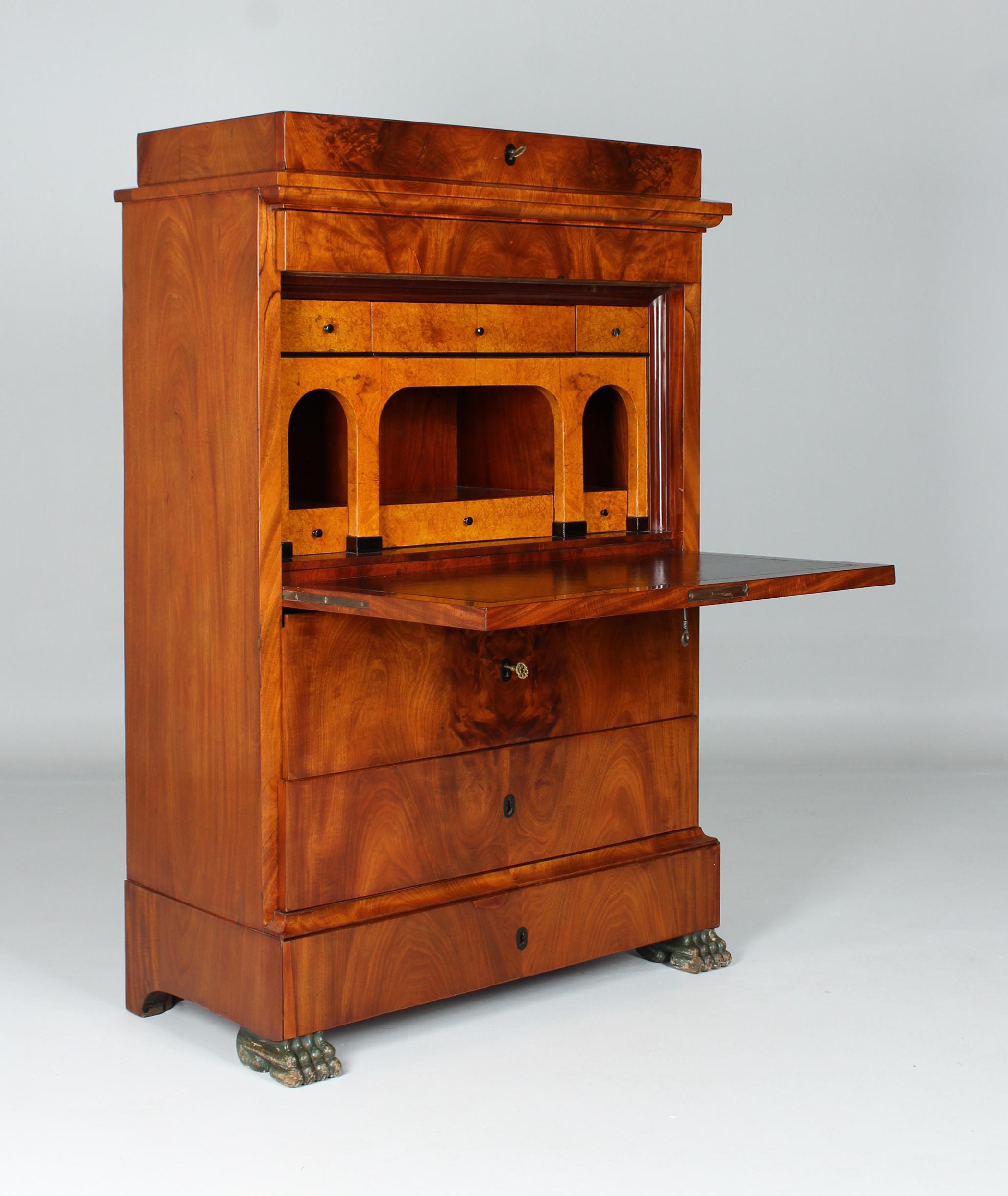 Antique standing secretary

North Germany
Biedermeier around 1830

Dimensions: H x W x D: 151 x 99 x 49 cm

Description:
Writing desk standing on lion's paws with a protruding plinth typical of the region.
We see a cleanly continuous grain pattern
