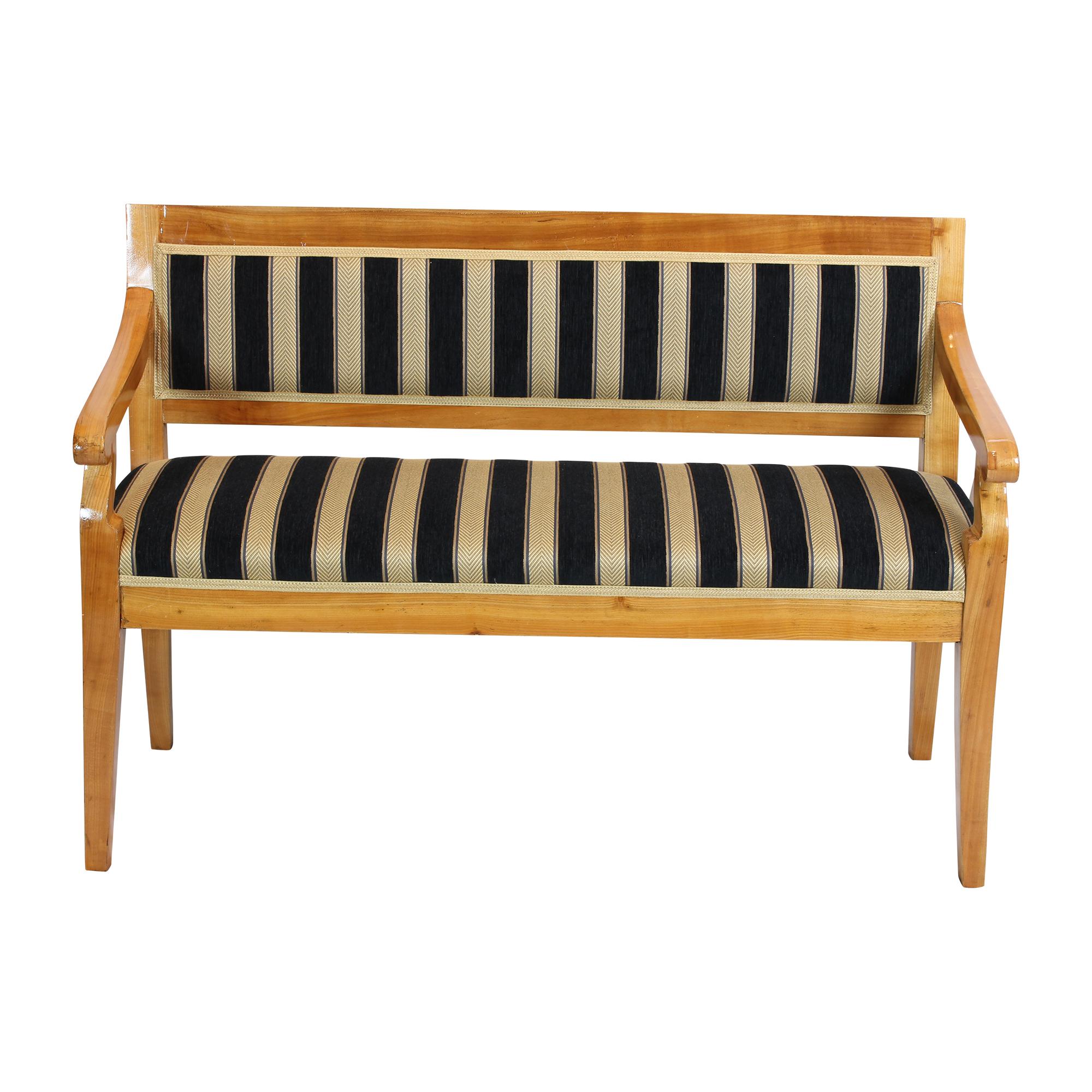 Extremely rare bench with small practical size from the Biedermeier period. The bench is made of cherry wood, partly veneered and partly solid. The bench has been reupholstered and re-covered with Biedermeier fabric. In very good restored condition.