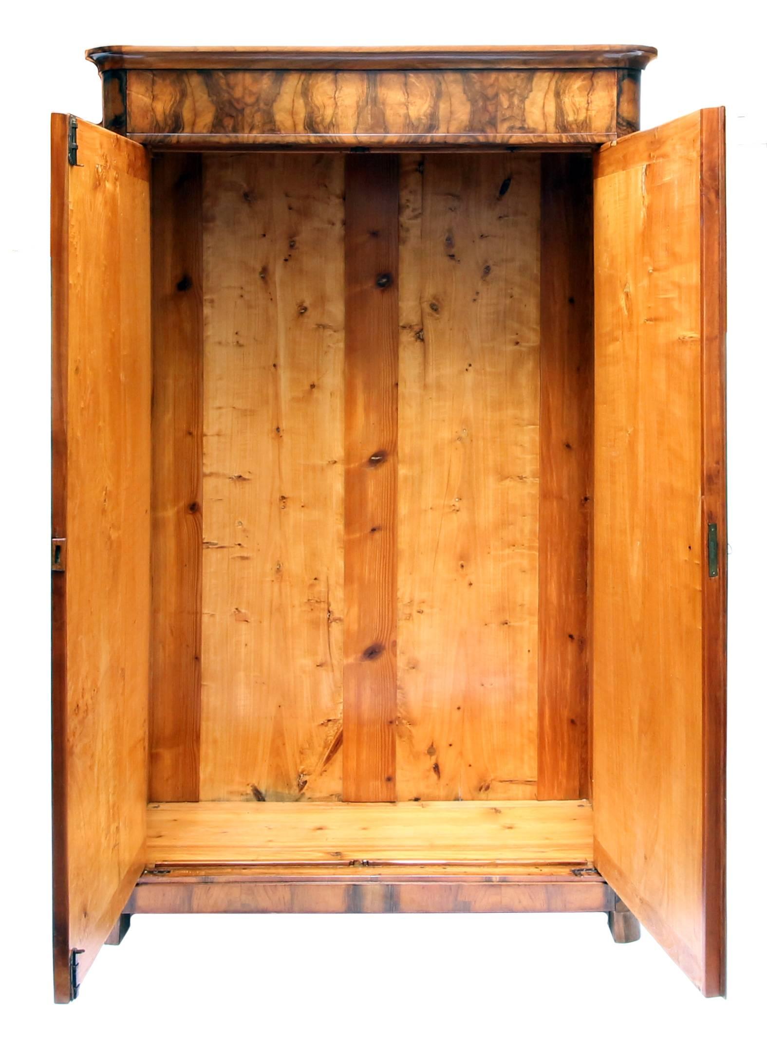 Wonderfully small walnut cabinet veneered on a pine body. The cabinet dates from the time of the Biedermeier period. In a very well restored condition. An interior division in the form of shelves is included in the price and will be made according