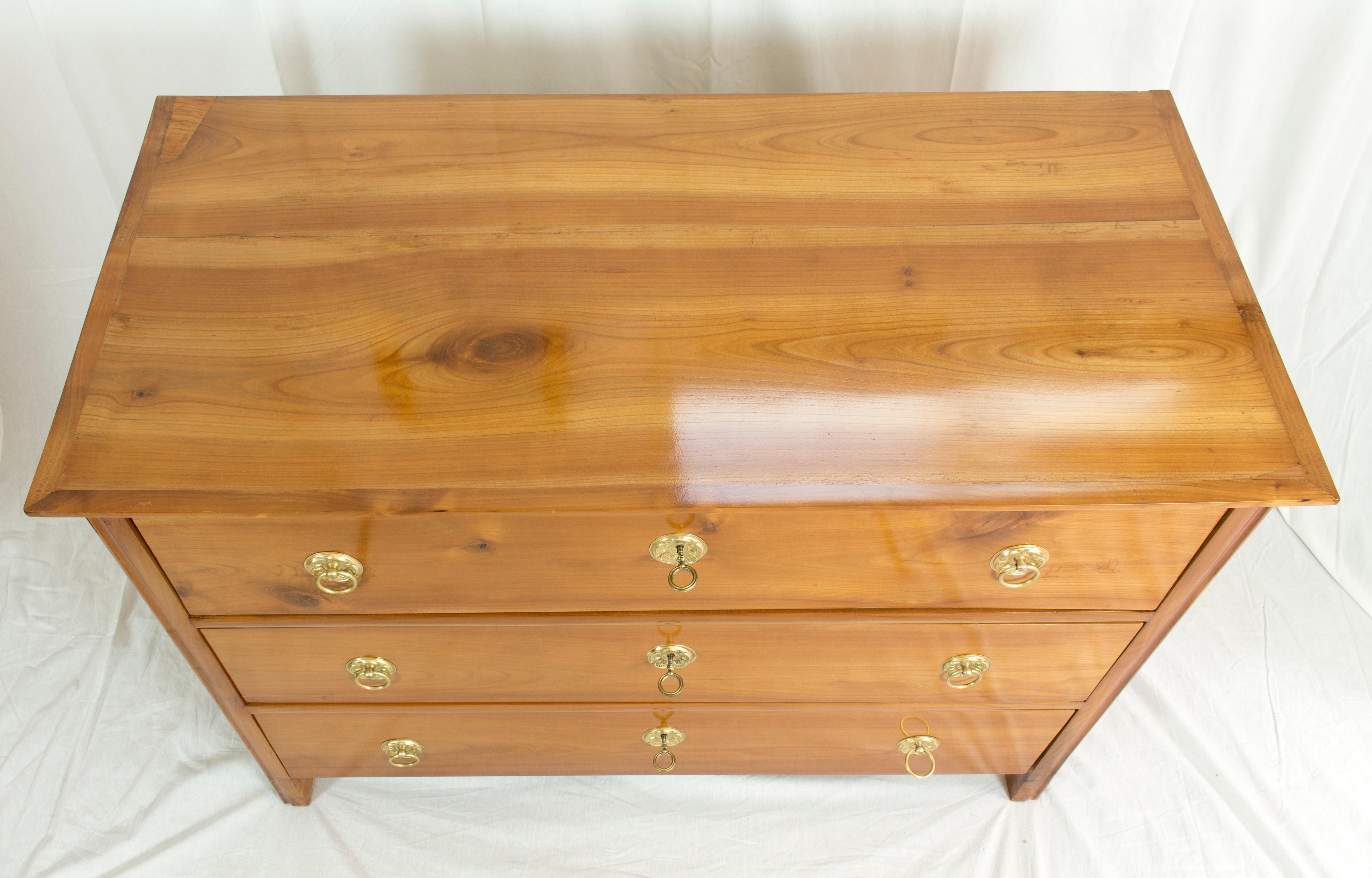 Very beautiful Biedermeier chest of drawers with three drawers. The commode is made of solid cherrywood and dates circa 1825 from Austria. The inside of the drawers is made of spruce wood, as usual. The locks and fittings are original. The fittings