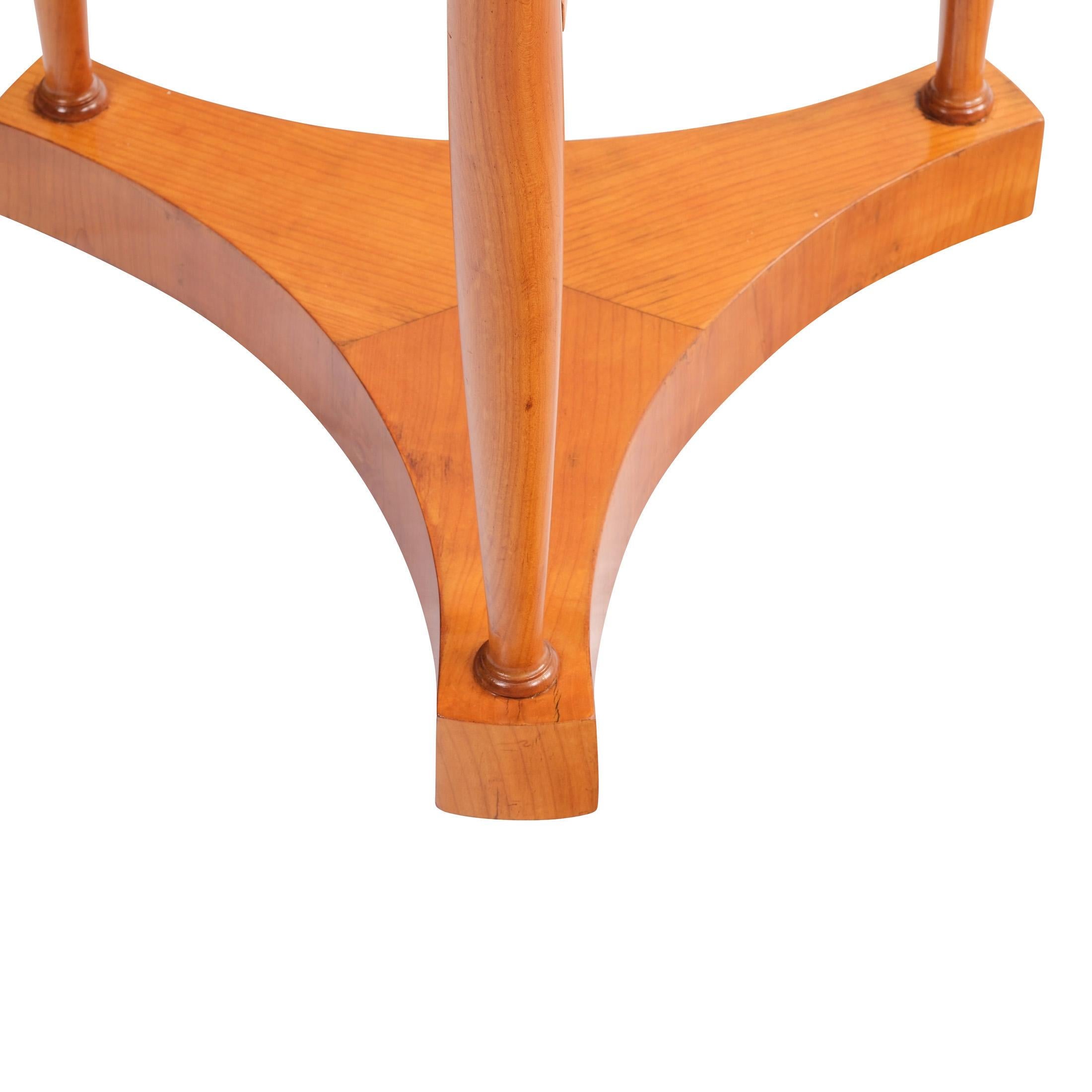 
Jardinière 

Germany, circa 1850/60, solid cherry wood and veneer, inlaid

swan motifs,

3-pass construction with solid columns and intermediate shelf, upper section with lids, which can be opened by means of a pressure mechanism, shellac