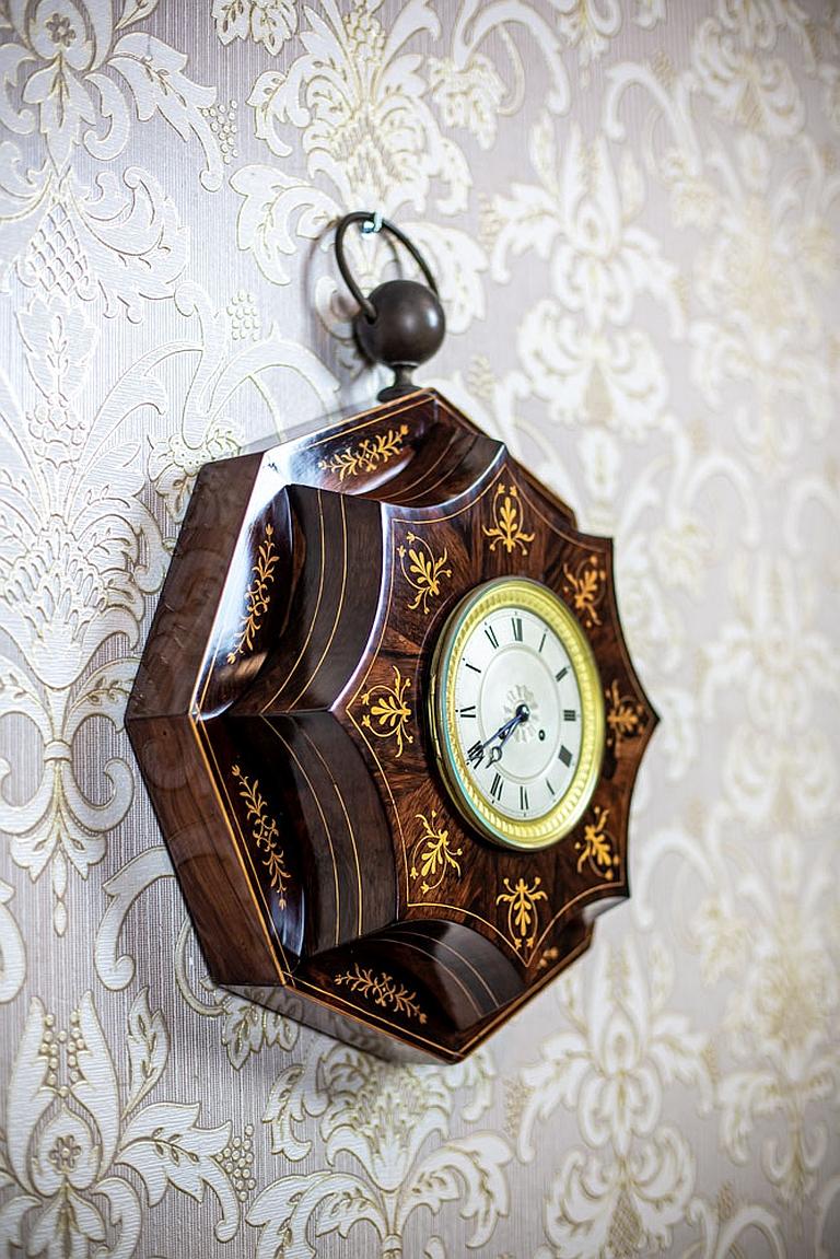 We present you this highly unique clock from the 1st half of the 19th century.
The mechanism is spring, with winding. The clock strikes full hours and halves.
Furthermore, the case is made of wood veneered with rosewood, and is decorated with
