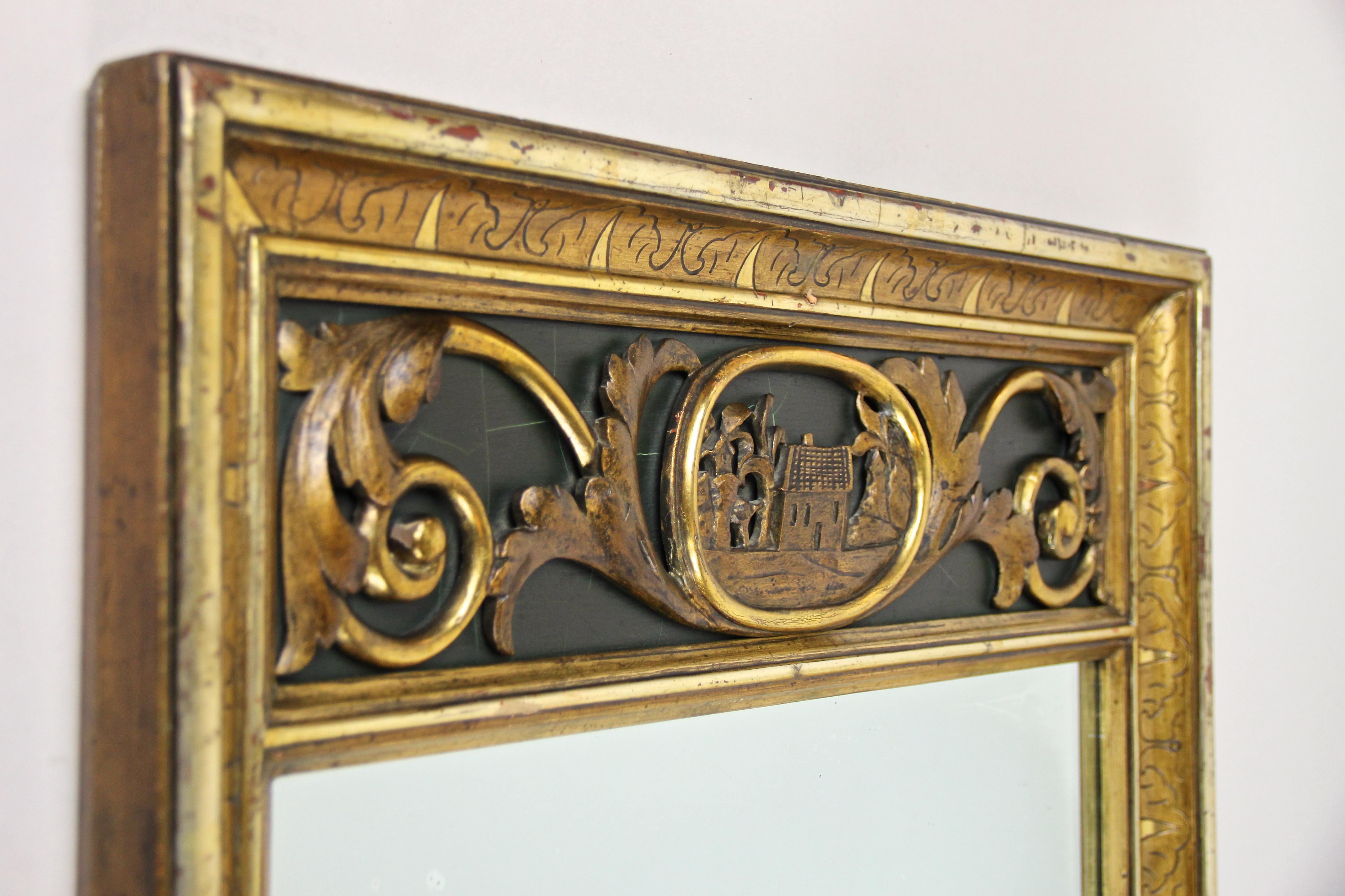 Remarkable 19th century gilt wall mirror or trumeau mirror from the early Biedermeier period in Austria, circa 1825. In absolute rare original condition - no former restorations has been done - comes this beautiful golden trumeau mirror with
