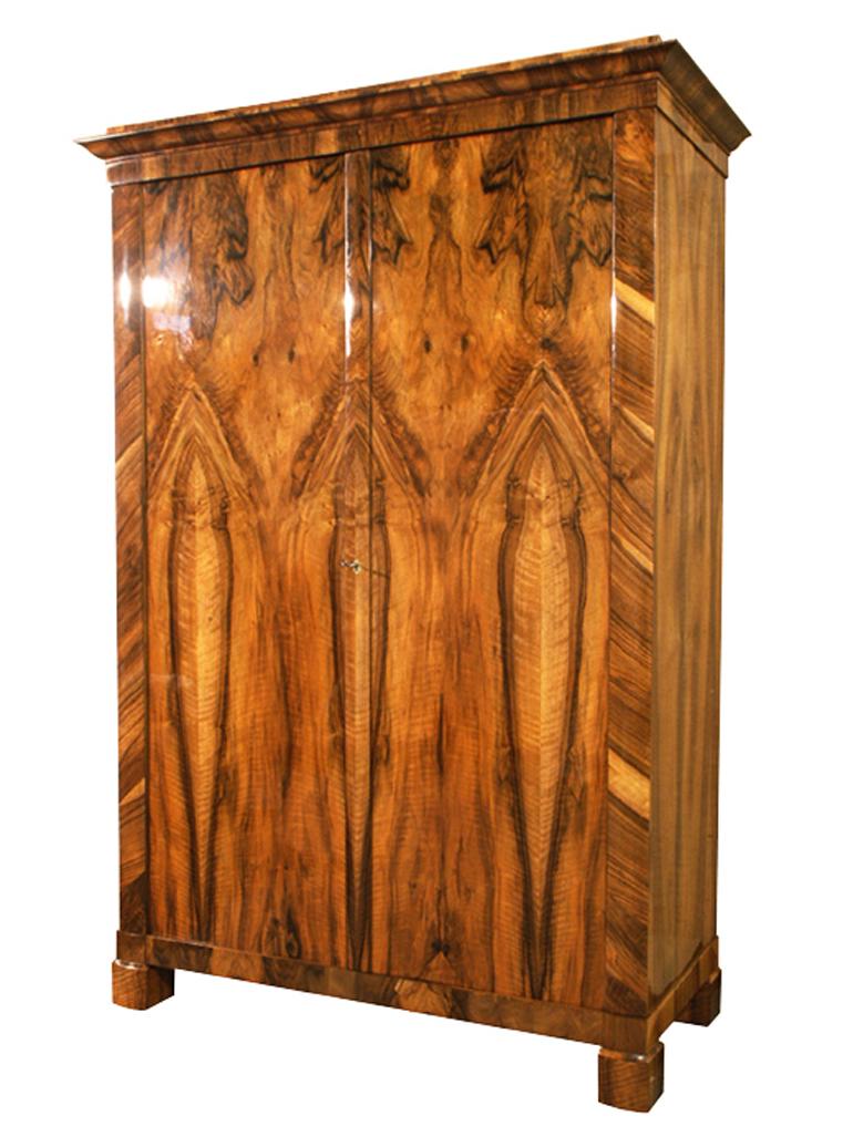Hello,
We would like to offer you this truly exquisite, early Biedermeier walnut armoire. The piece was made in Vienna circa 1825.

Viennese Biedermeier is distinguished by their sophisticated proportions, rare and refined design and excellent