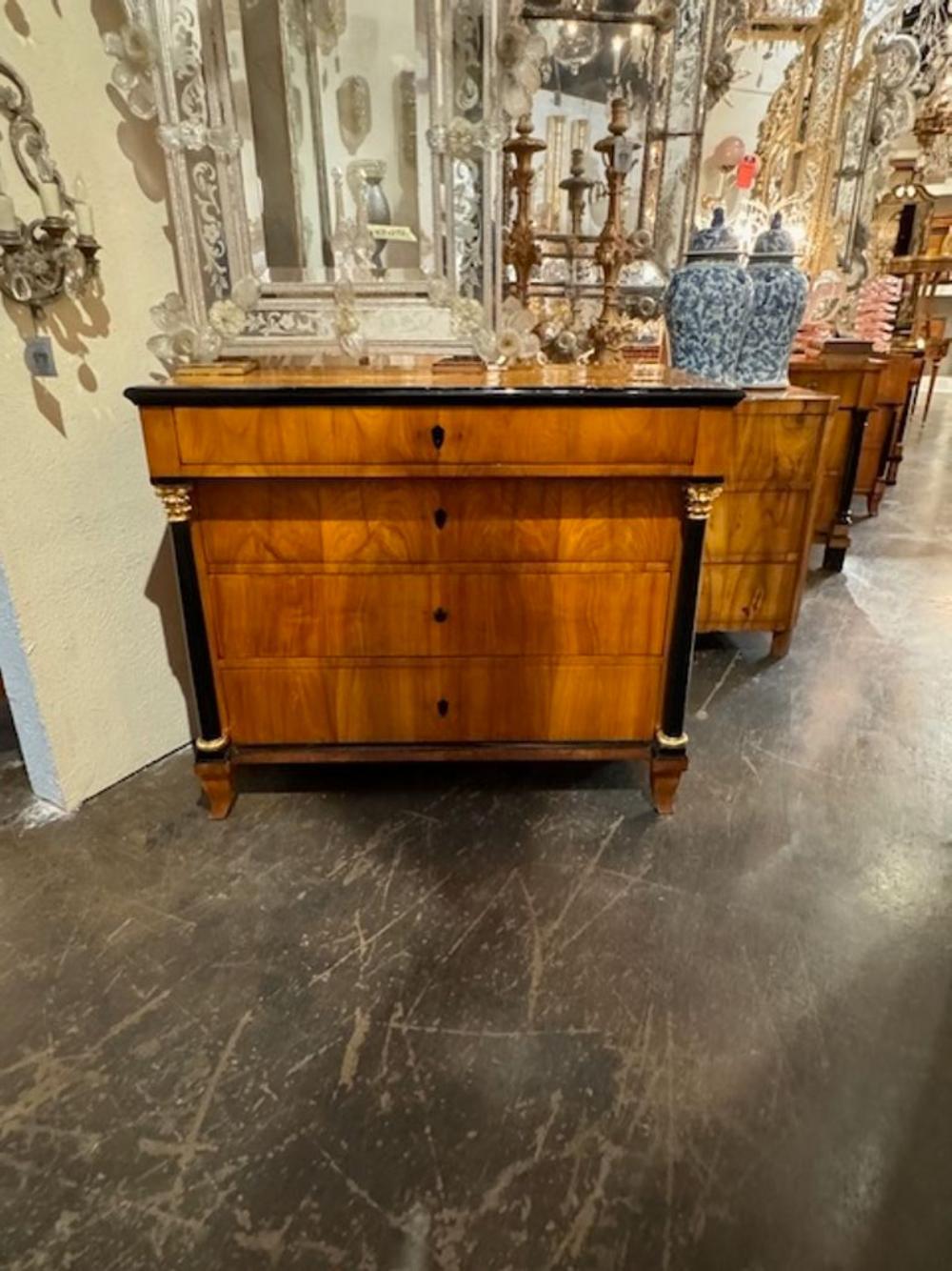 Handsome German Walnut Biedermeier commode with ebonized details. Featuring very fine wood grain and four drawers for storage. A superb piece with exceptional quality!!