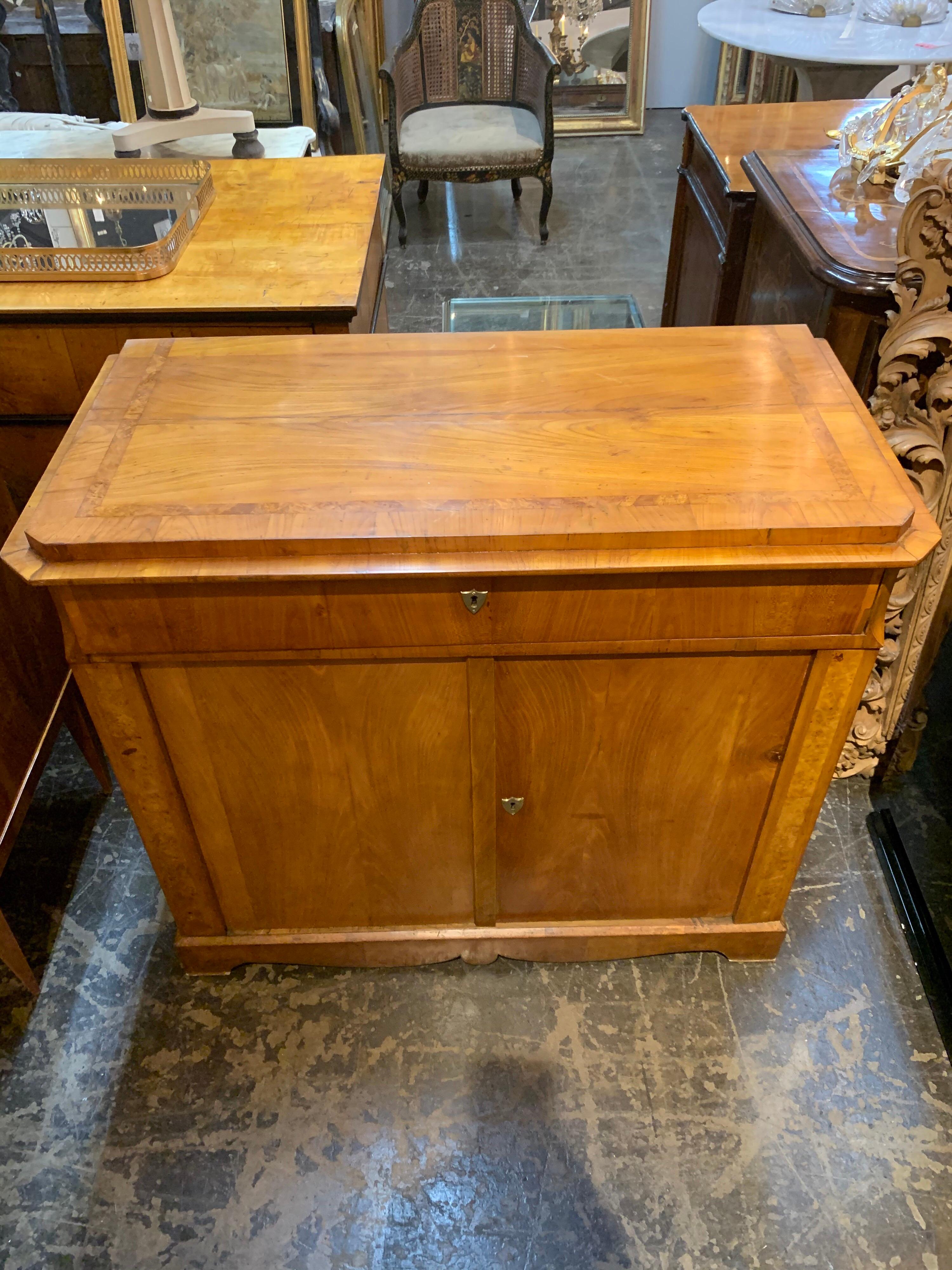 Lovely 19th century Biedermeier walnut credenza. The cabinet has a drawer and 2 shelves for storage. A very handsome and functional piece that could be used in a variety of settings!