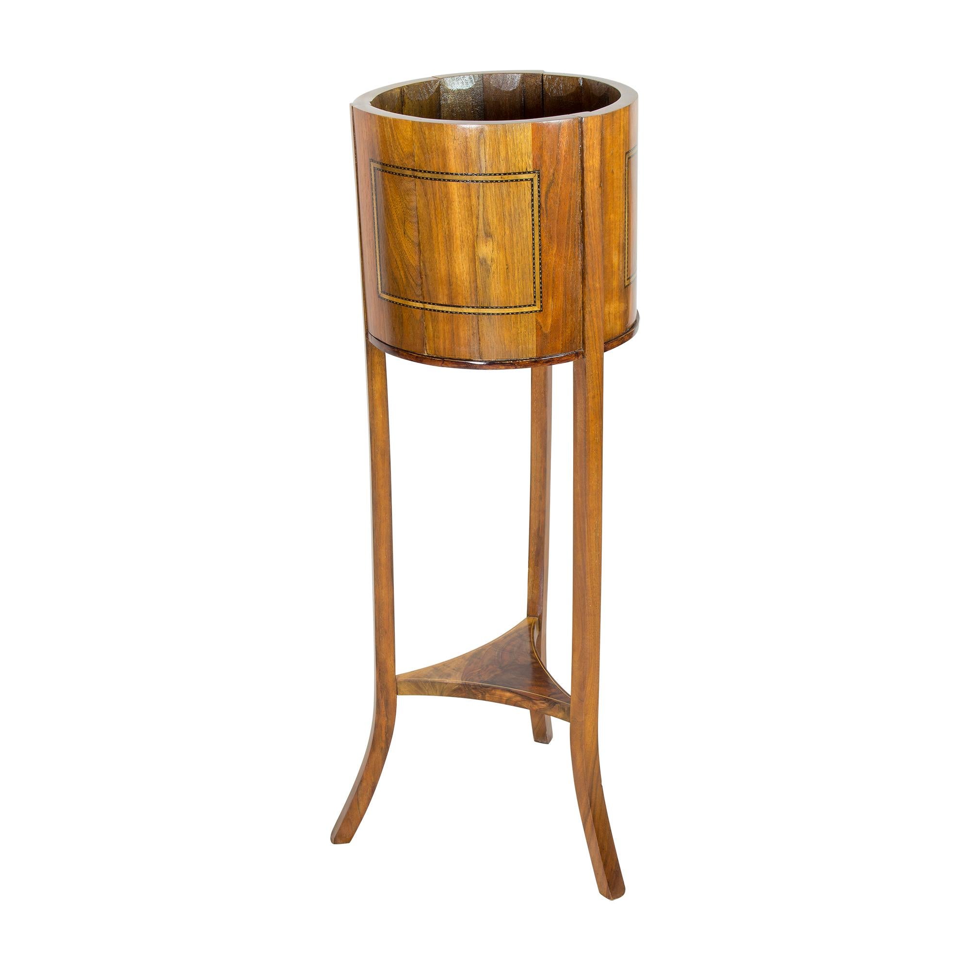 This antique piece of furniture is a truly remarkable and unique example of Biedermeier style, made from beautiful and durable walnut wood. The elegant and understated design of this piece, which can be used as either a flower stand or a wine and