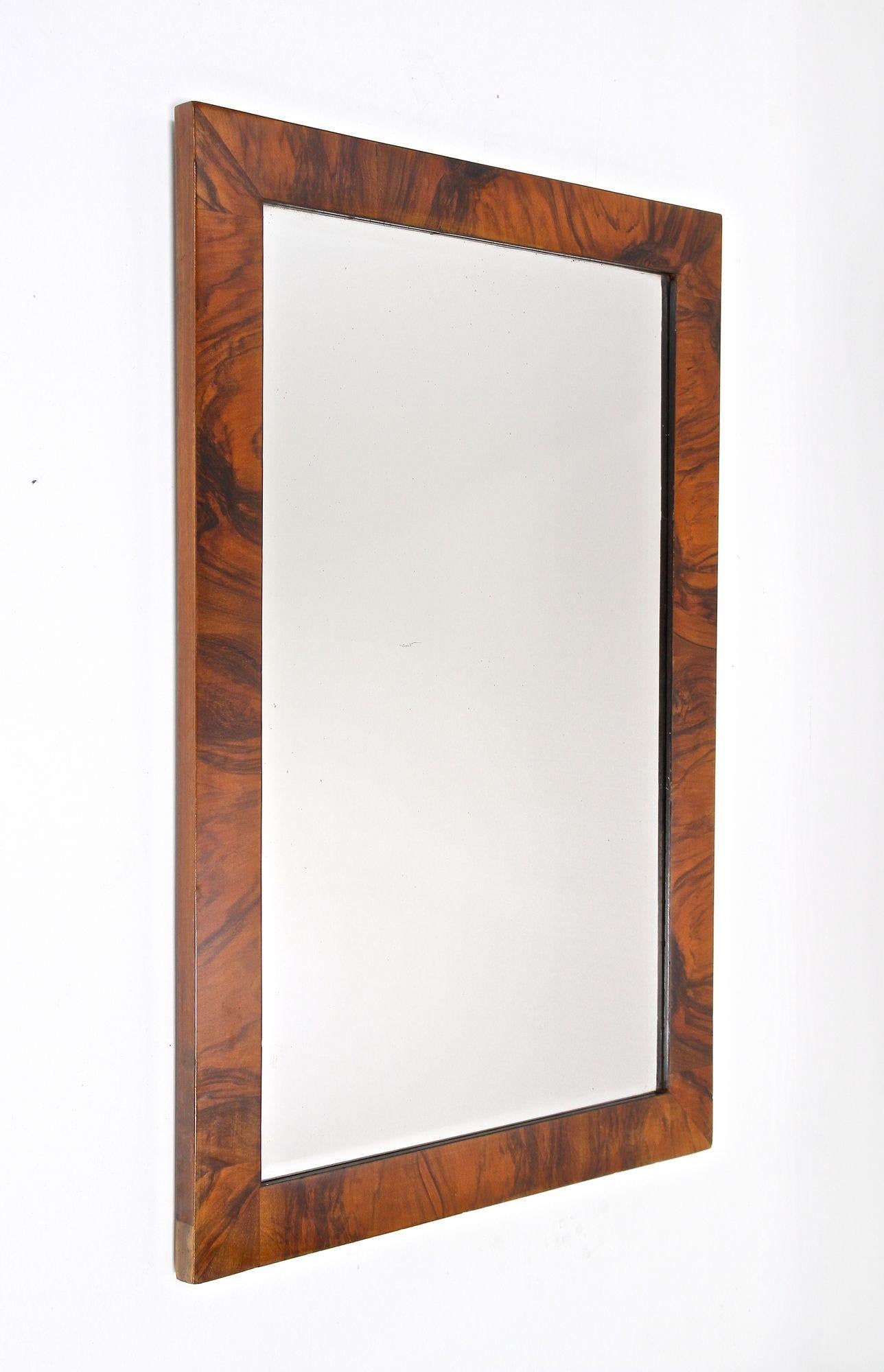 Fantastic early 19th century wall mirror from the famous Biedermeier period in Vienna/ Austria. This magnificent, large wall mirror from the early Biedermeier era around 1825 comes with a traditional overlapped substructure made of spruce wood and