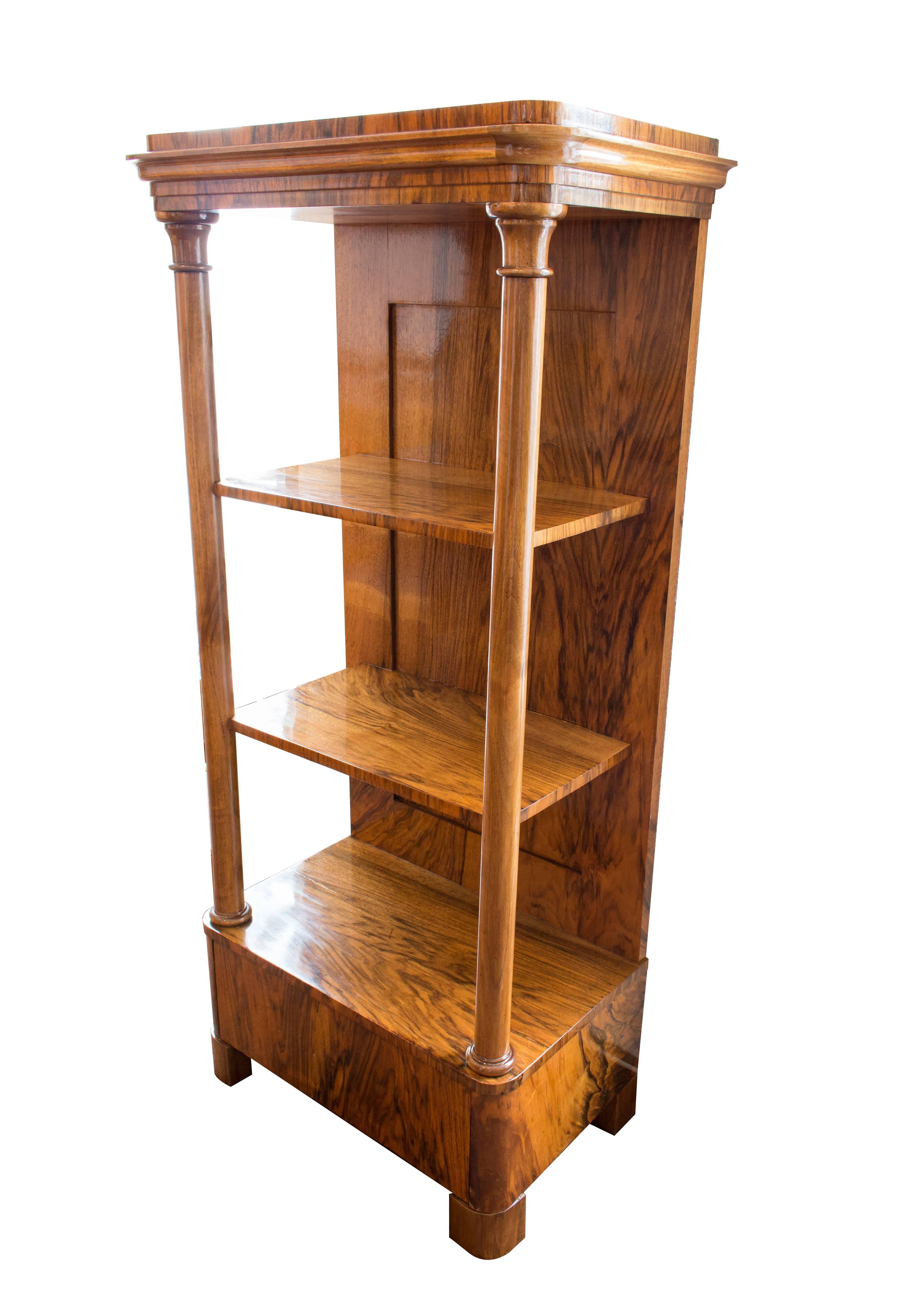 Very nice little pillar etagere from the time of Biedermeier, circa 1820. The etagere is walnut veneered on pine wood. The columns are made of solid walnut. There is a drawer in the base. In very good restored condition.