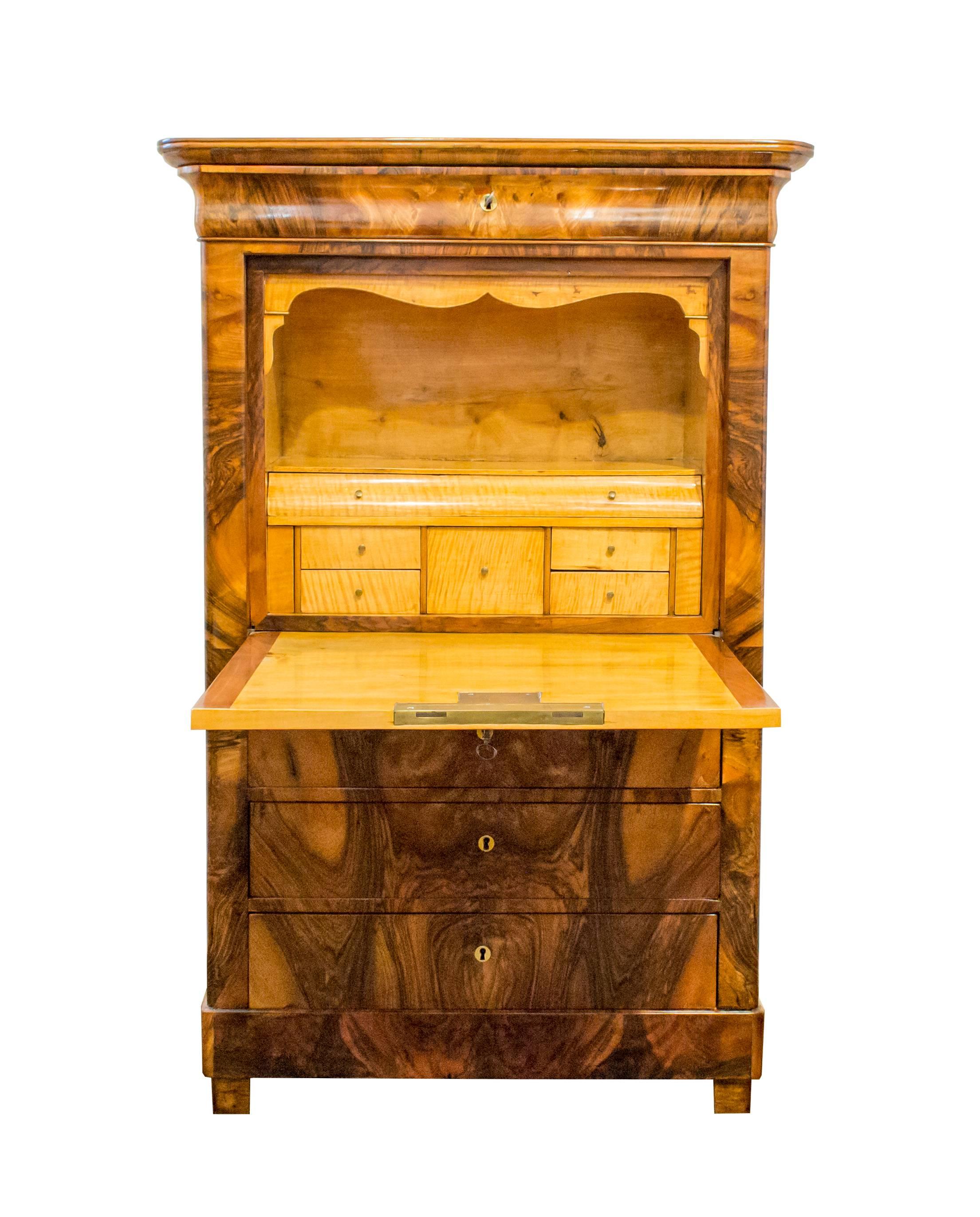A beautiful small Secretaire made of walnut veneer from the time of Biedermeier.
The interior of the Secretaire is made of birchwood. In very good restored condition.
 