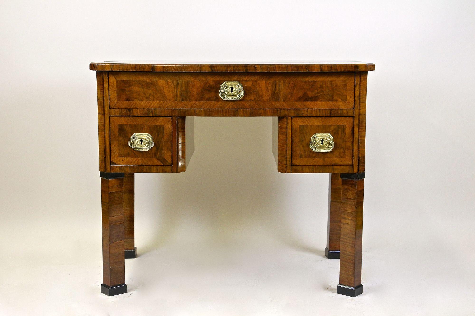 One of a kind, rare 19th century Biedermeier writing desk out of Austria veneered in fine nutwood/ walnut. Artfully crafted around 1830 in Vienna, this delicate Biedermeier so-called 