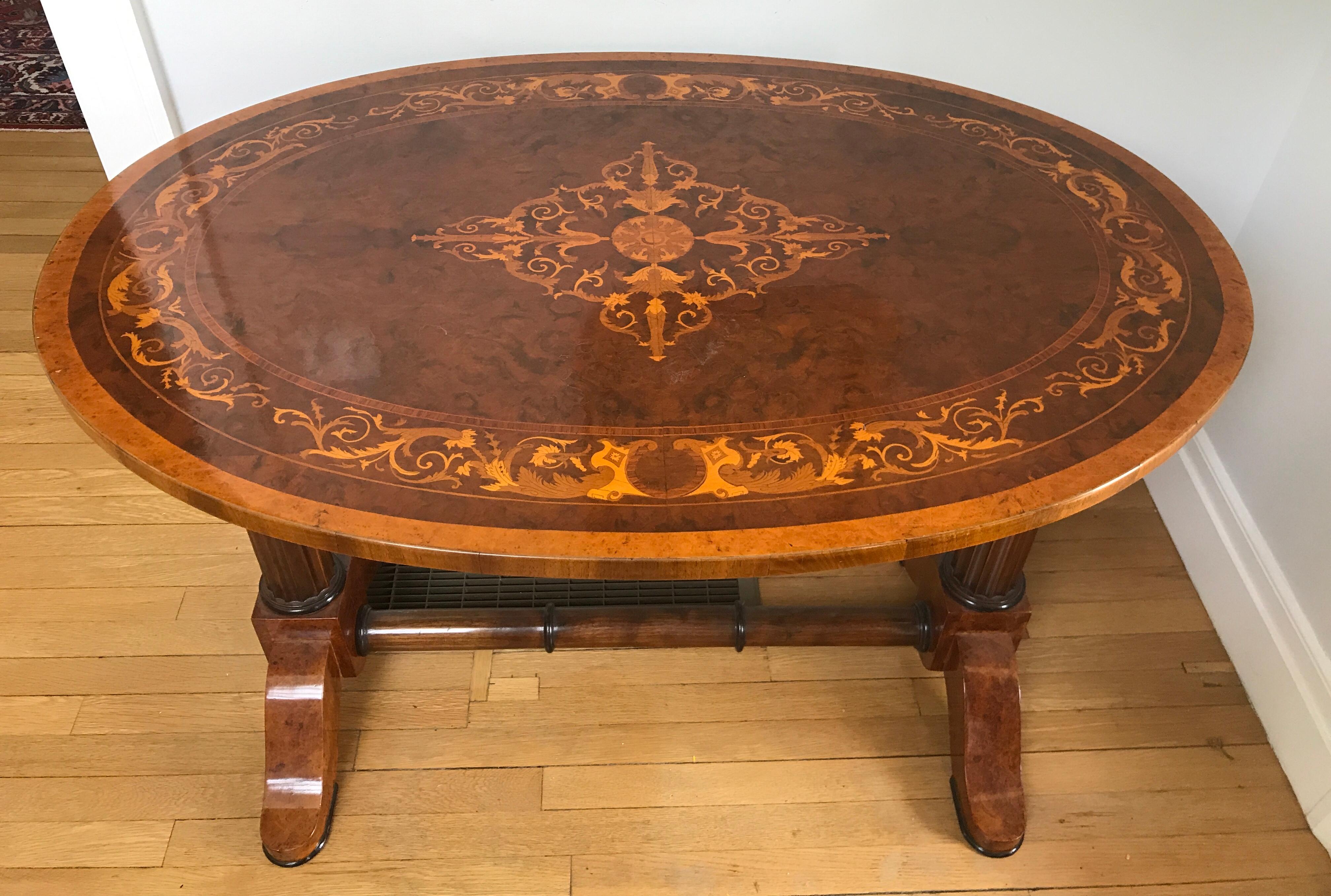 Unique oval 19th century Biedermeier writing table, Hungary circa 1820-1830, bird's-eye maple veneer, burl walnut and elmwood veneer with akanthus leave marquetry on the top. The table has one drawer. Great design with beautiful details. The table