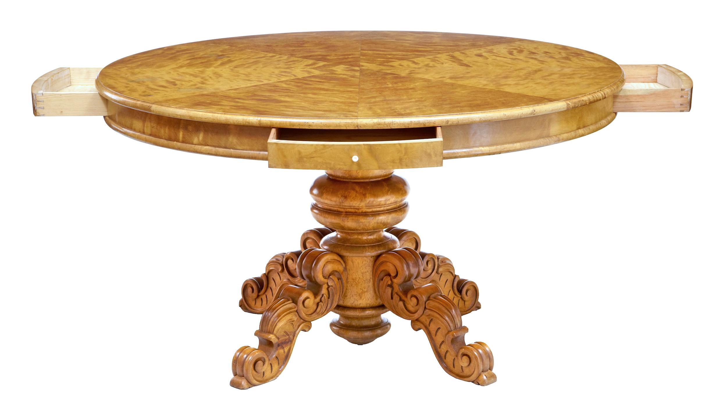 19th century birch Swedish carved drum centre table, circa 1890.

Large circular center table, with 4 shallow drawers placed at equal positions around the edge. Top arranged with segmented veneer to provide a striking appearance.

Top has an