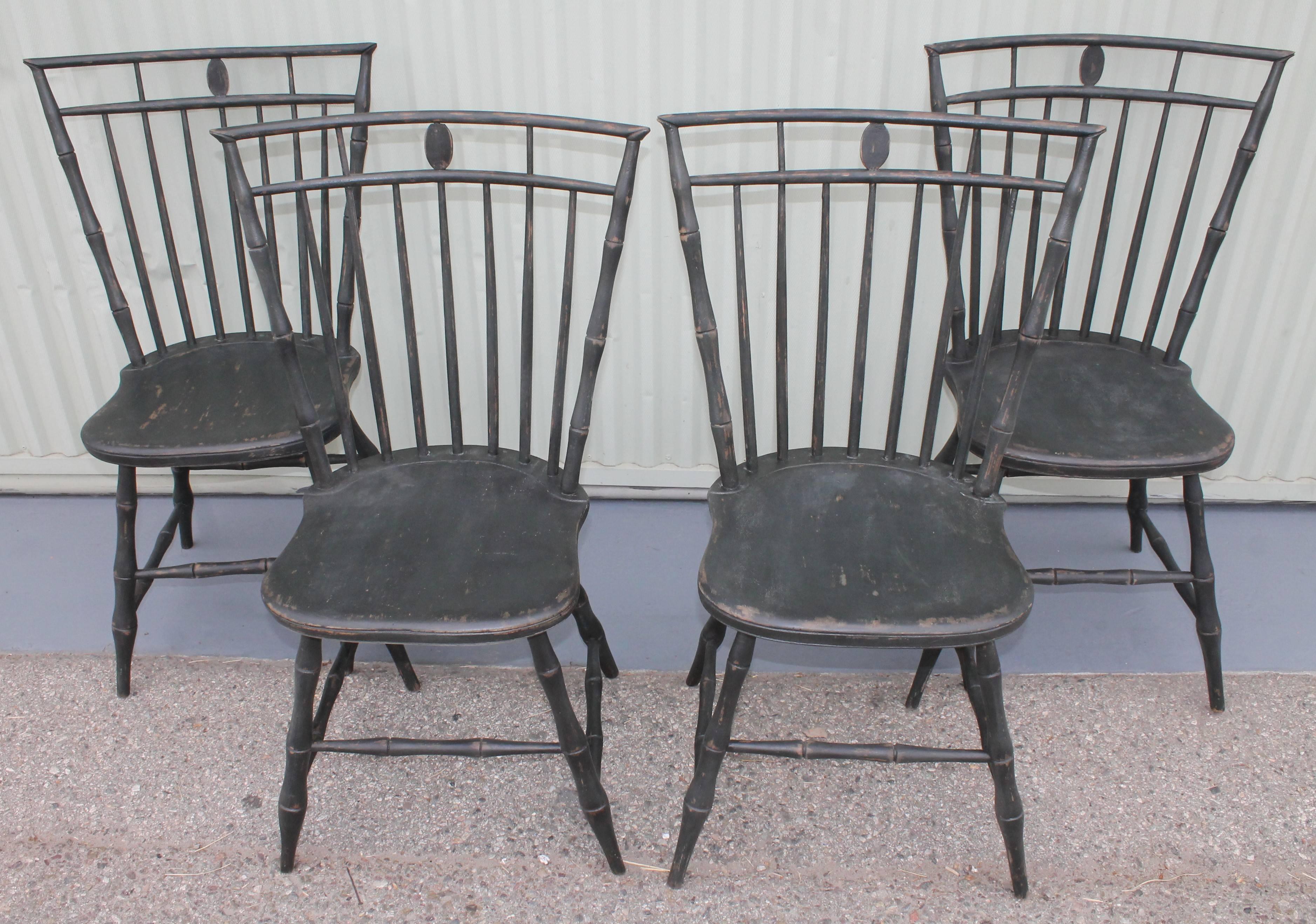 19th century green painted Windsor chairs in fine condition with wear consistent from age and use. This set of four matching chairs are very strong and sturdy. They are super comfortable and great looking. This is a second generation painted