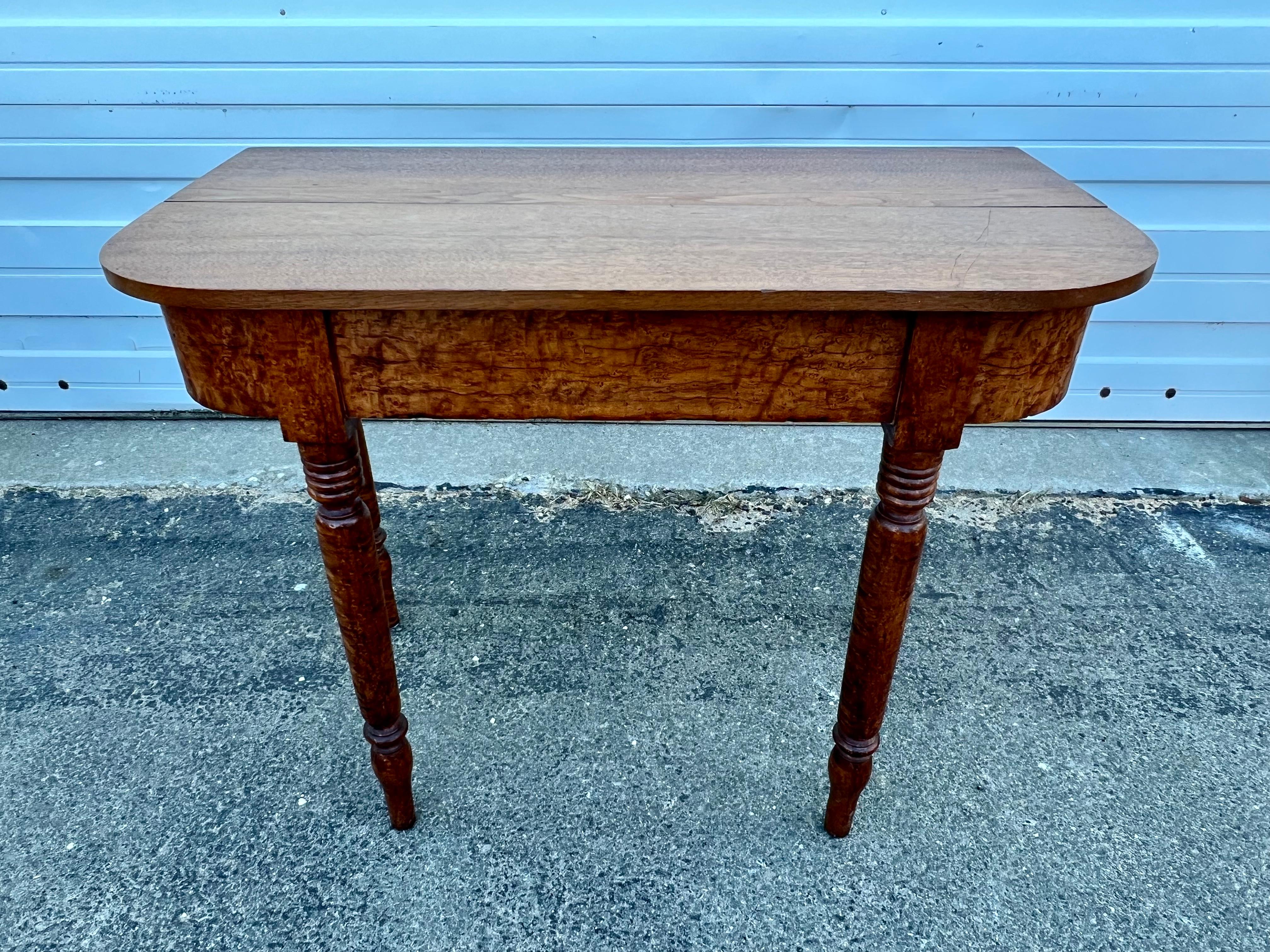Lovely 19th century console table crafted from Birdseye maple.  Top with rounded front corners, on nicely turned legs.  