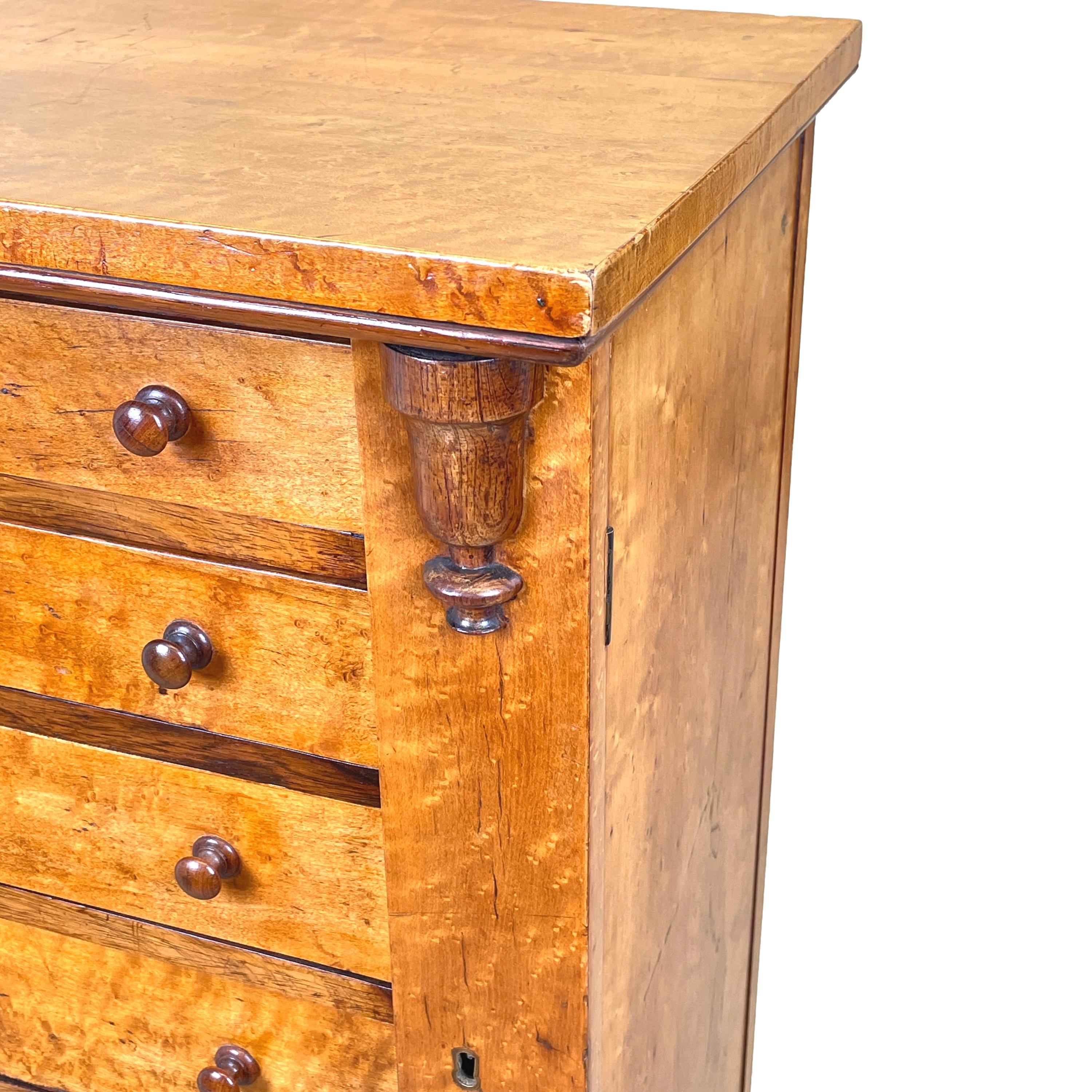 A delightful mid 19th century birds eye maple wood wellington chest of seven
drawers retaining original turned wooden knobs flanked by pilasters headed
with carved corbels raised on original plinth base

(It is believed that the first Duke of