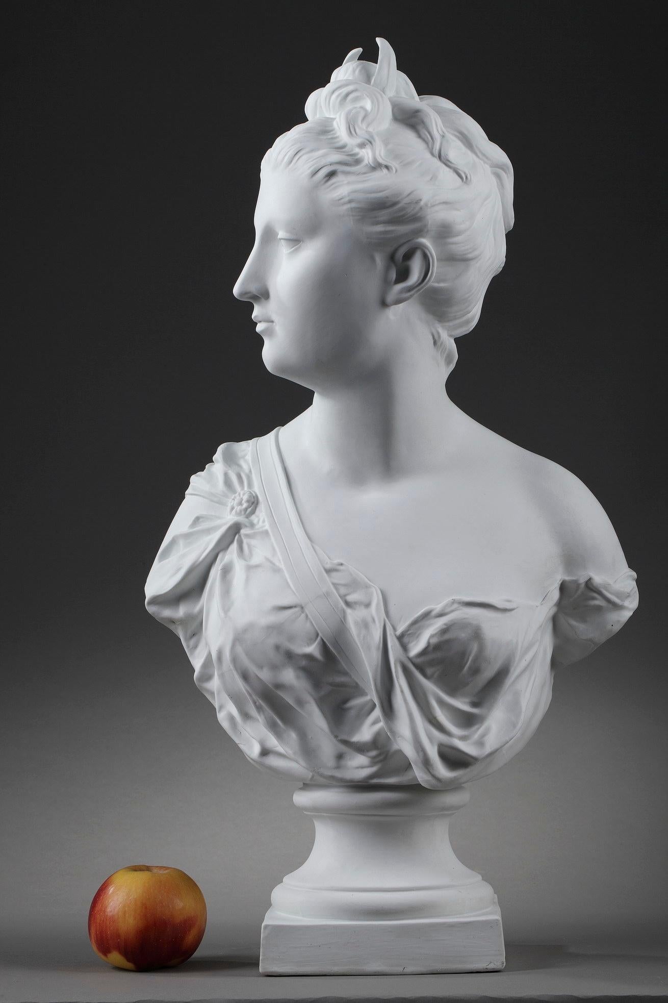 This bust crafted of bisque porcelain features Diana the Huntress after Jean-Antoine Houdon (French, 1741- 1828). Diana, in Roman mythology, is the goddess of wild animals and hunt, identified with the Greek goddess Artemis. Our biscuit statue is