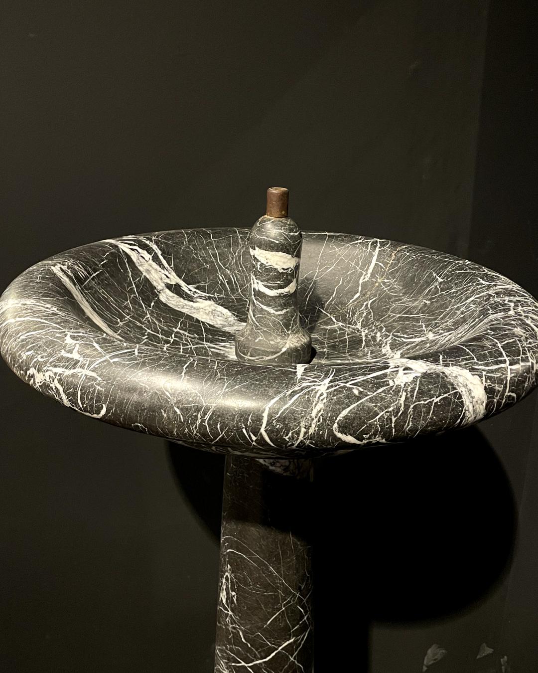 Transport your surroundings to the refined splendor of the 19th century with our Black and Grey Marble Fountain. Crafted with meticulous attention to detail, this exquisite piece captures the essence of timeless elegance. The marble, characterized
