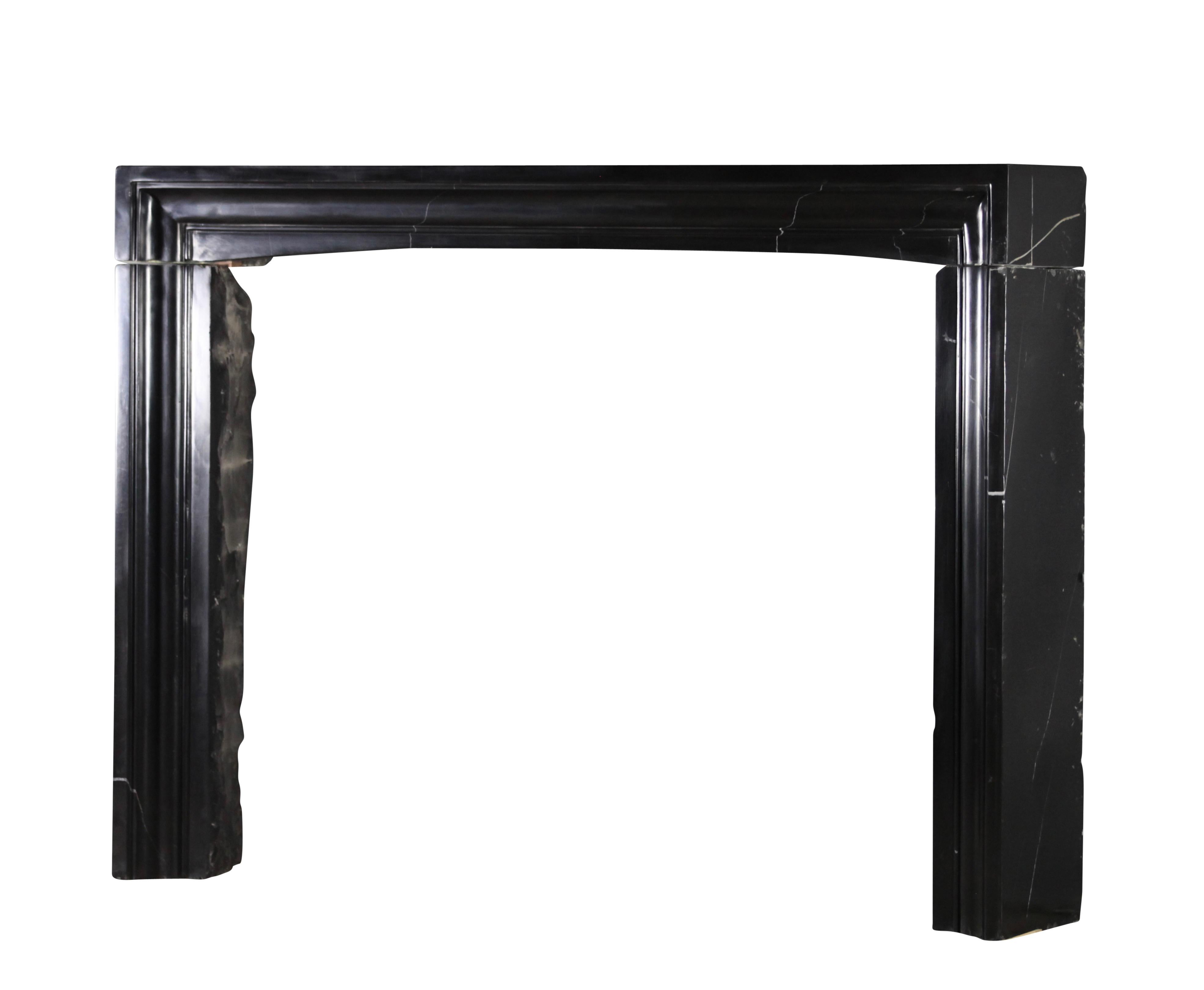 This one of a kind original antique fireplace mantle is one of a collection of four that was reclaimed out of a Brussels great Maison de Maître house. The mantle is executed in the bespoke Black Belgian Marble. This strong piece is a perfect fit