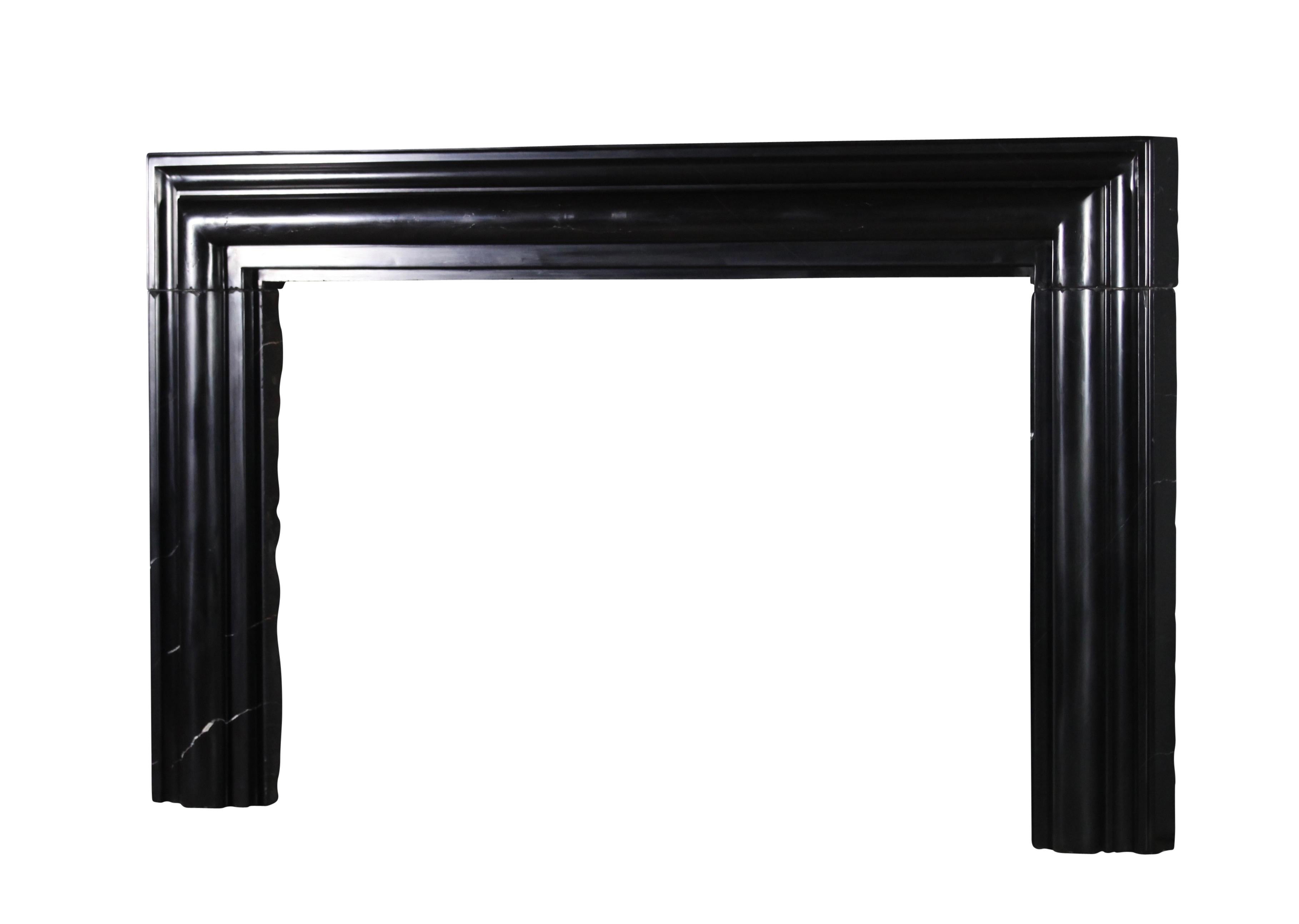 This one of a kind original antique fireplace is one of a collection of four special surrounds. The collection was reclaimed out of Brussels Great Maison de Maitre house.
It was executed in the bespoke Belgian Black marble. The size of this one is