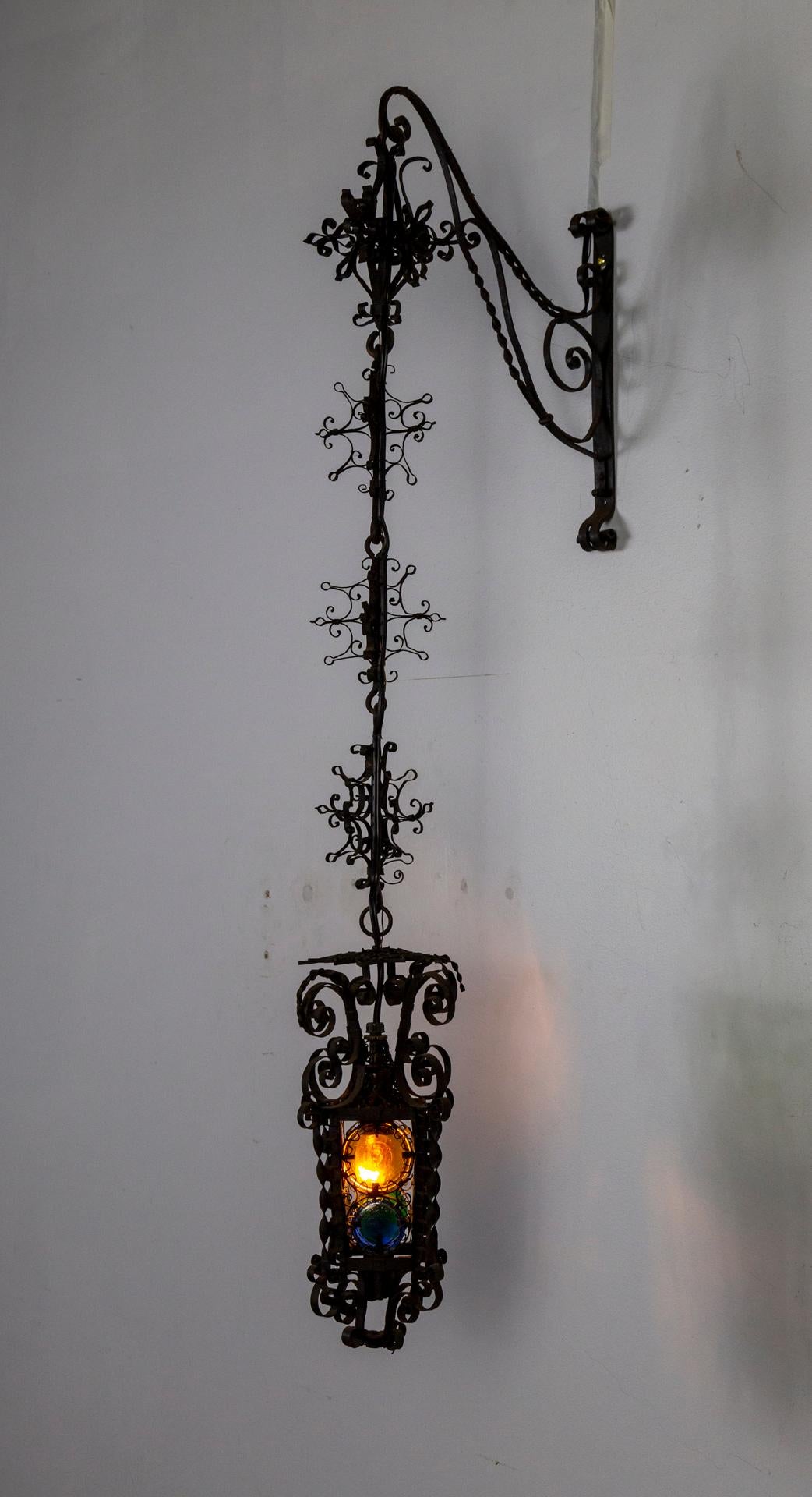 19th Century Black Filigree Iron Hanging Wall Lantern W/ Colored Glass In Good Condition For Sale In San Francisco, CA
