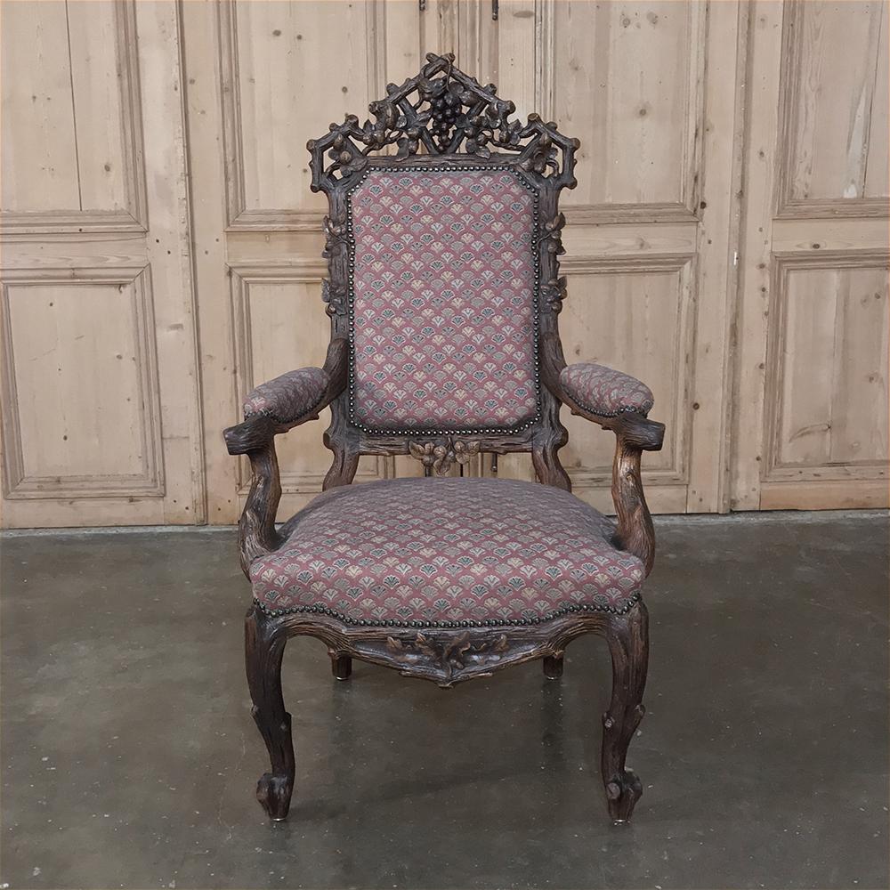 19th century black forest armchair is not only beautiful to behold, it's amazingly comfortable as well! Exquisitely carved framework depicts the natural flora of the region, celebrating the abundance of nature that exists, including the clusters of