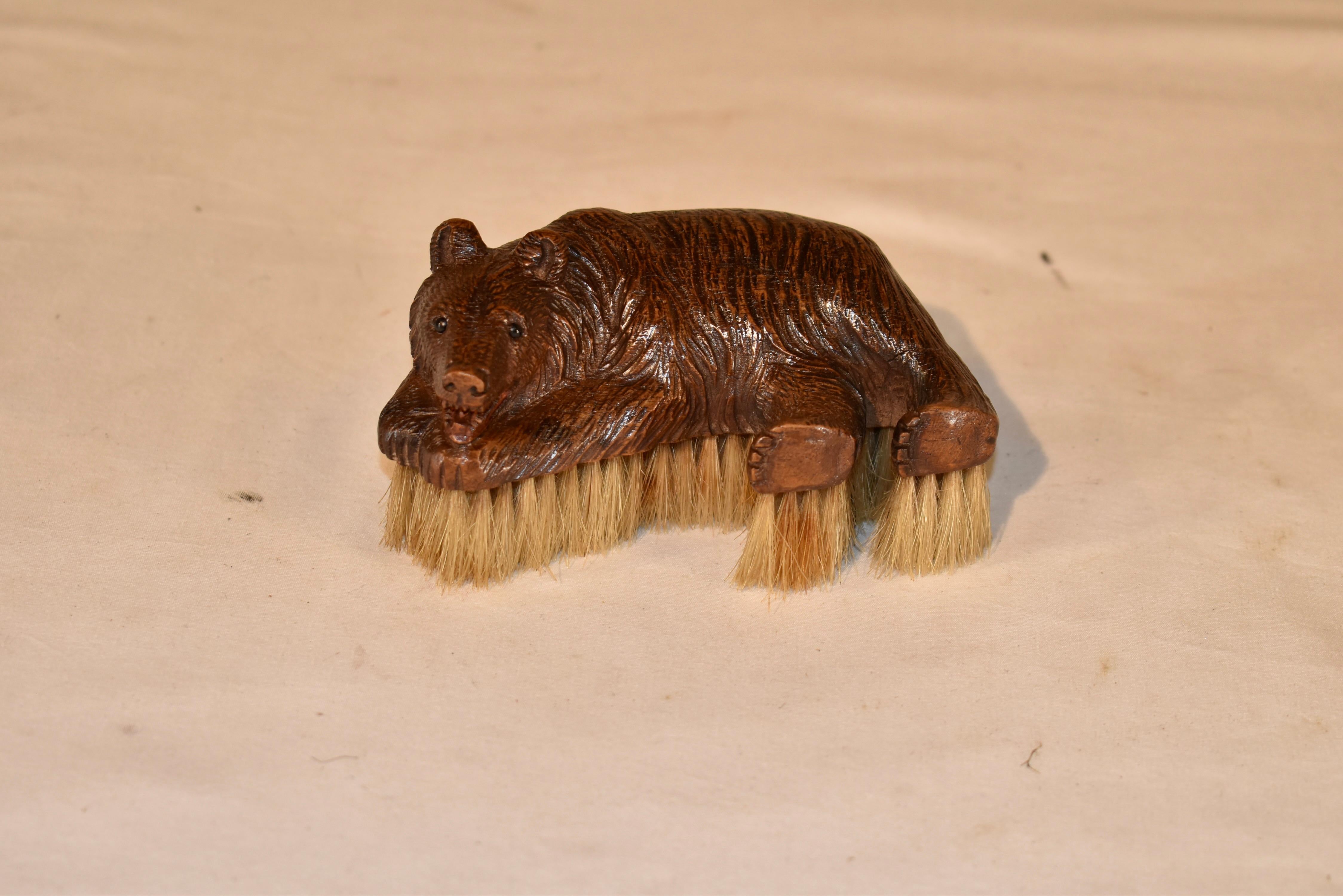 19th century hand carved Black Forest clothes brush in the form of a bear.  The bear is recumbent, and his face is so sweet - he will look good anywhere you decide to place him in your home or office.