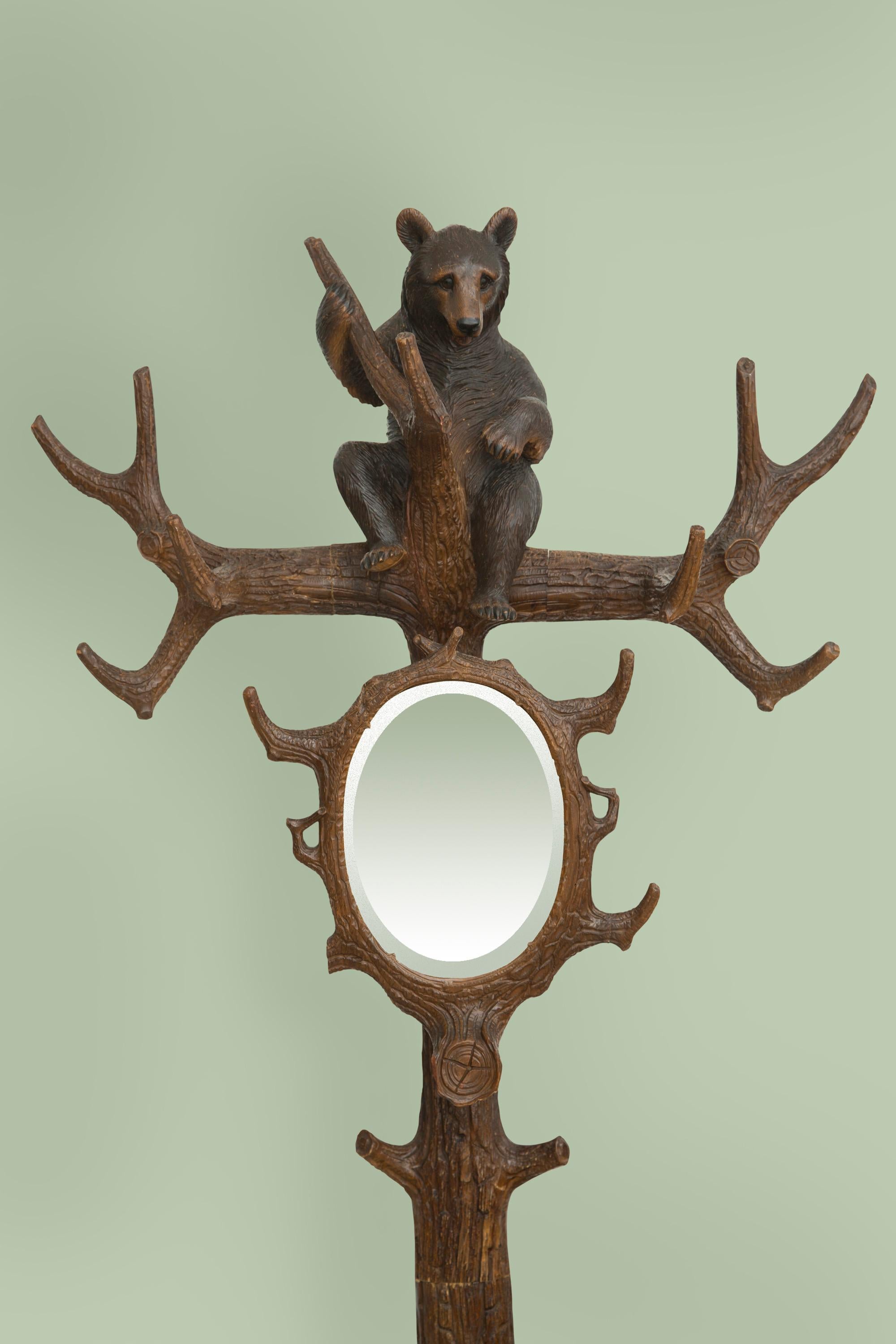 19th century Black Forest carved bears hall tree with umbrella stand and original beveled glass mirror. Finely detailed expert carving and glass eyes.