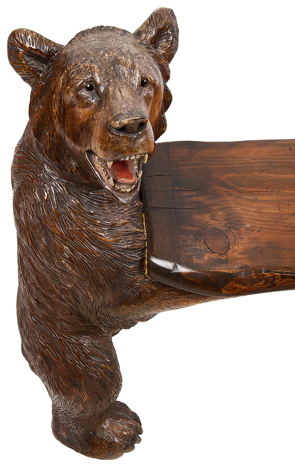 A good quality 19th century Black Forest carved bench, having two bears standing on their hind legs supporting the wooden seat. Measures: 41