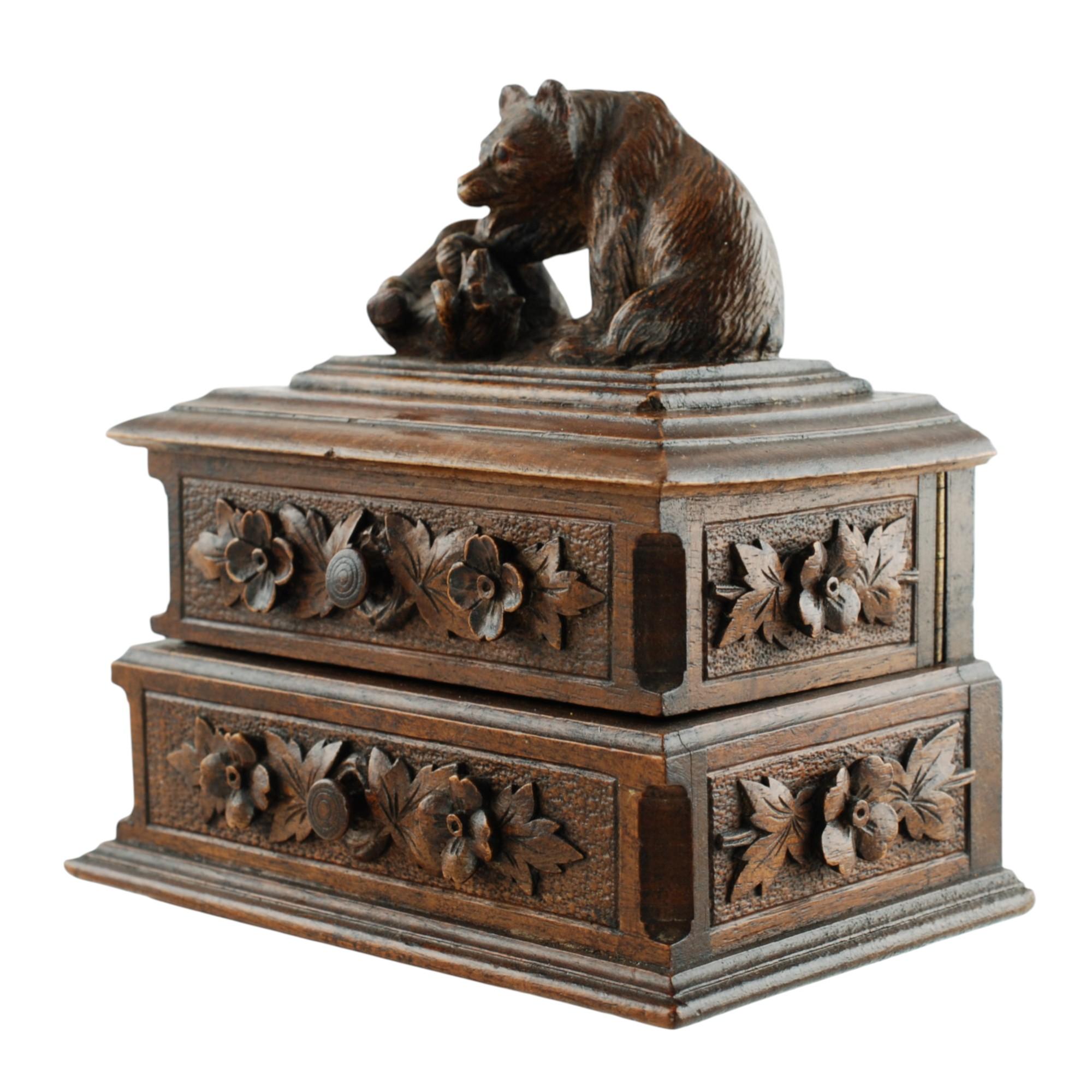 This unusual antique Black Forest box features a pair of fully dimensional bears cavorting at the base of a tree stump. The mother and cub have been finished with a high level of detail including glass eyes in the larger bear's head. The bears are