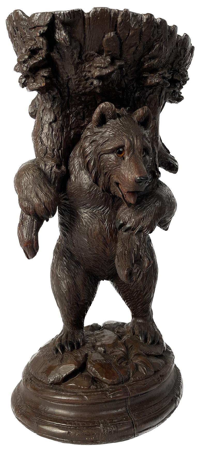 Late 19th century Swiss black Forest carved standing bear with tree bowl at top.

Dimensions: 6.5