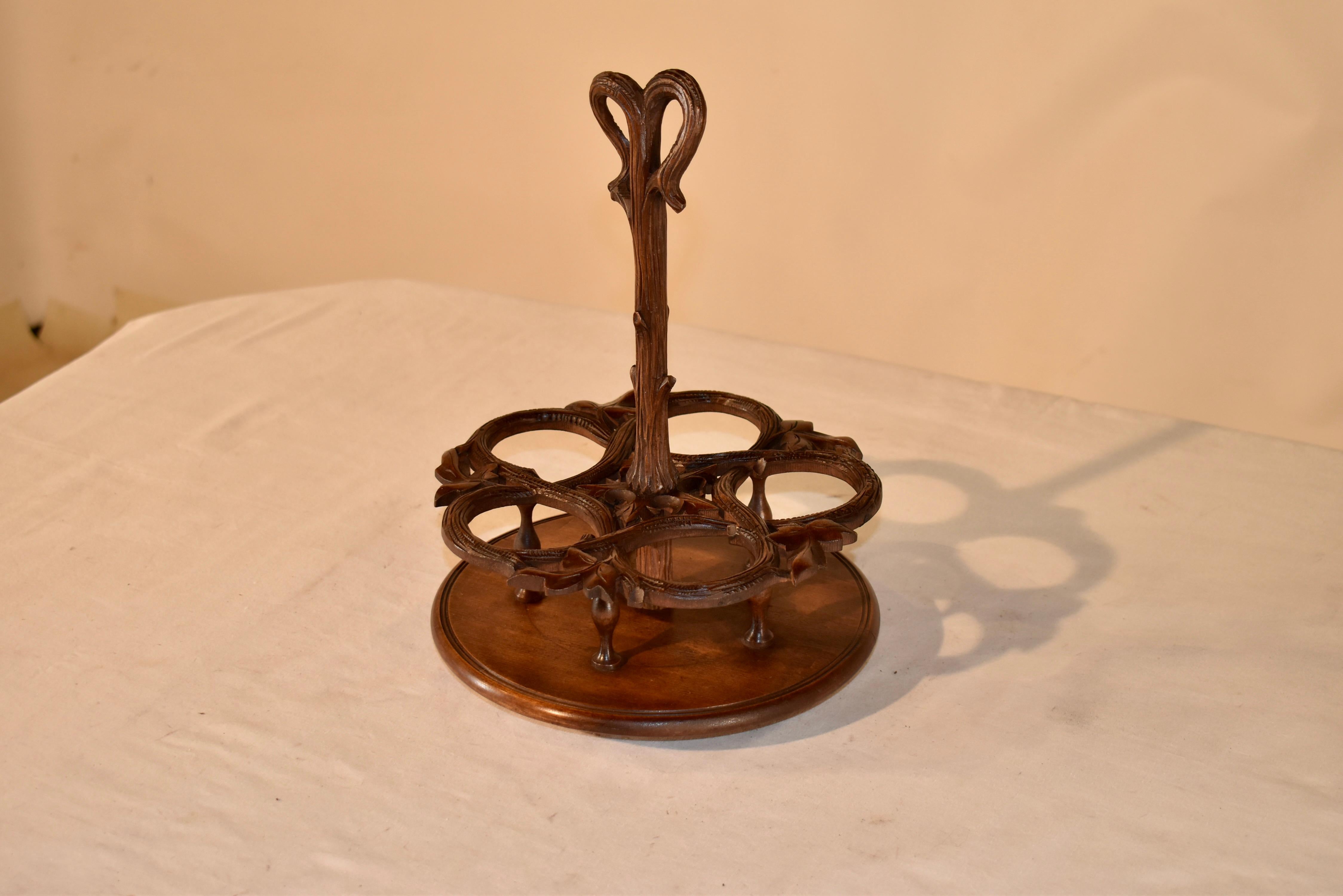 Lovely 19th century drink or condiment caddy hand carved in the Black Forest region of Europe.  The central stem handle of the caddy is hand carved to look like a branch, and follows down to a five opening caddy, also carved in the same manner.  The