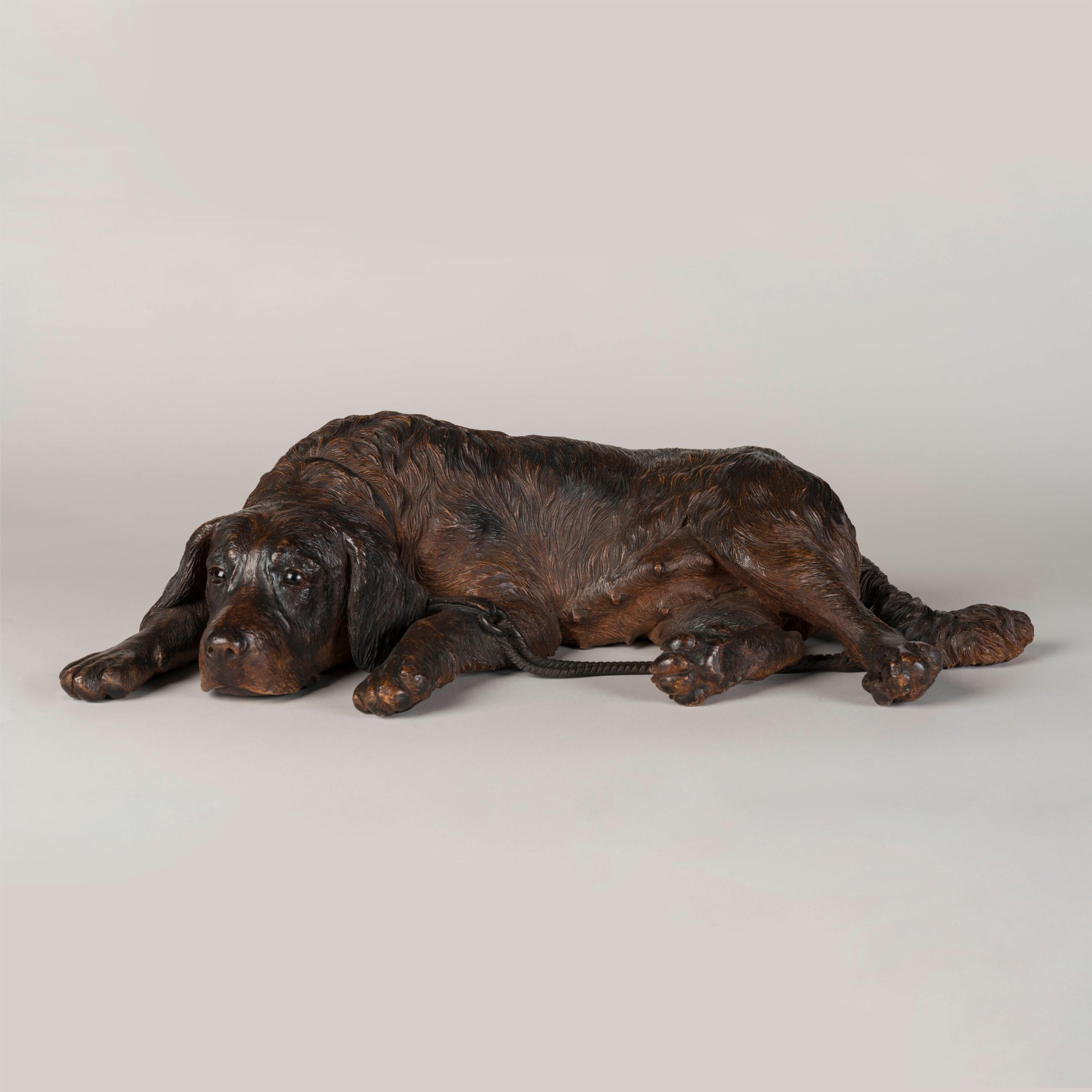 A 'Black Forest' Carved Dog

Constructed in naturalistically carved and stained lindenwood, the recumbent dog complete with a carved collar, lead, and glass inset eyes.
Brienz area, circa 1890

Brienz, in the Bernese Oberland, Switzerland was