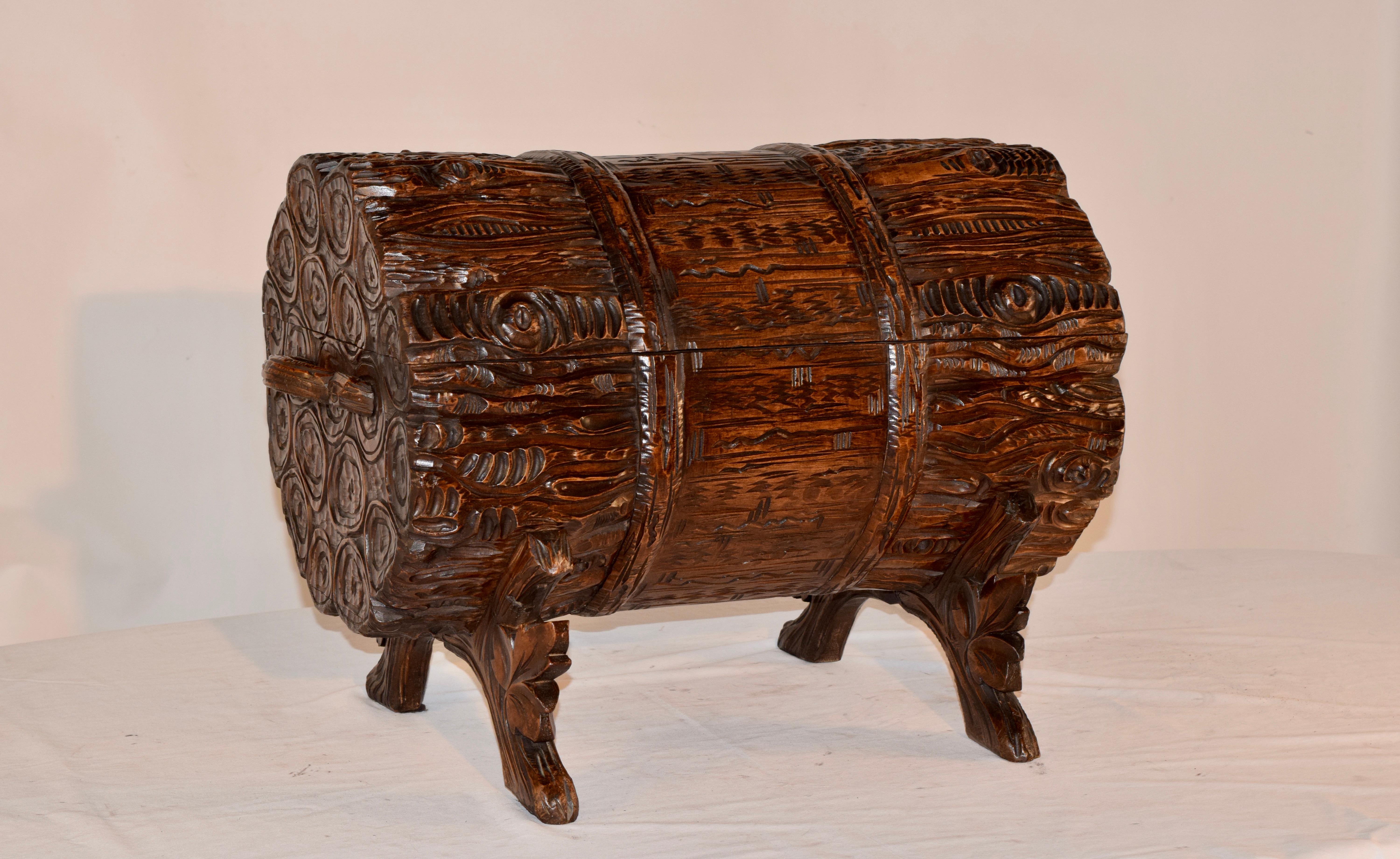 19th century masterfully hand carved Black Forest trunk in the shape of a bundle of logs. This top opens to reveal a lined storage area. This is supported on hand carved and shaped legs which are in the form of branches with leaf decoration.