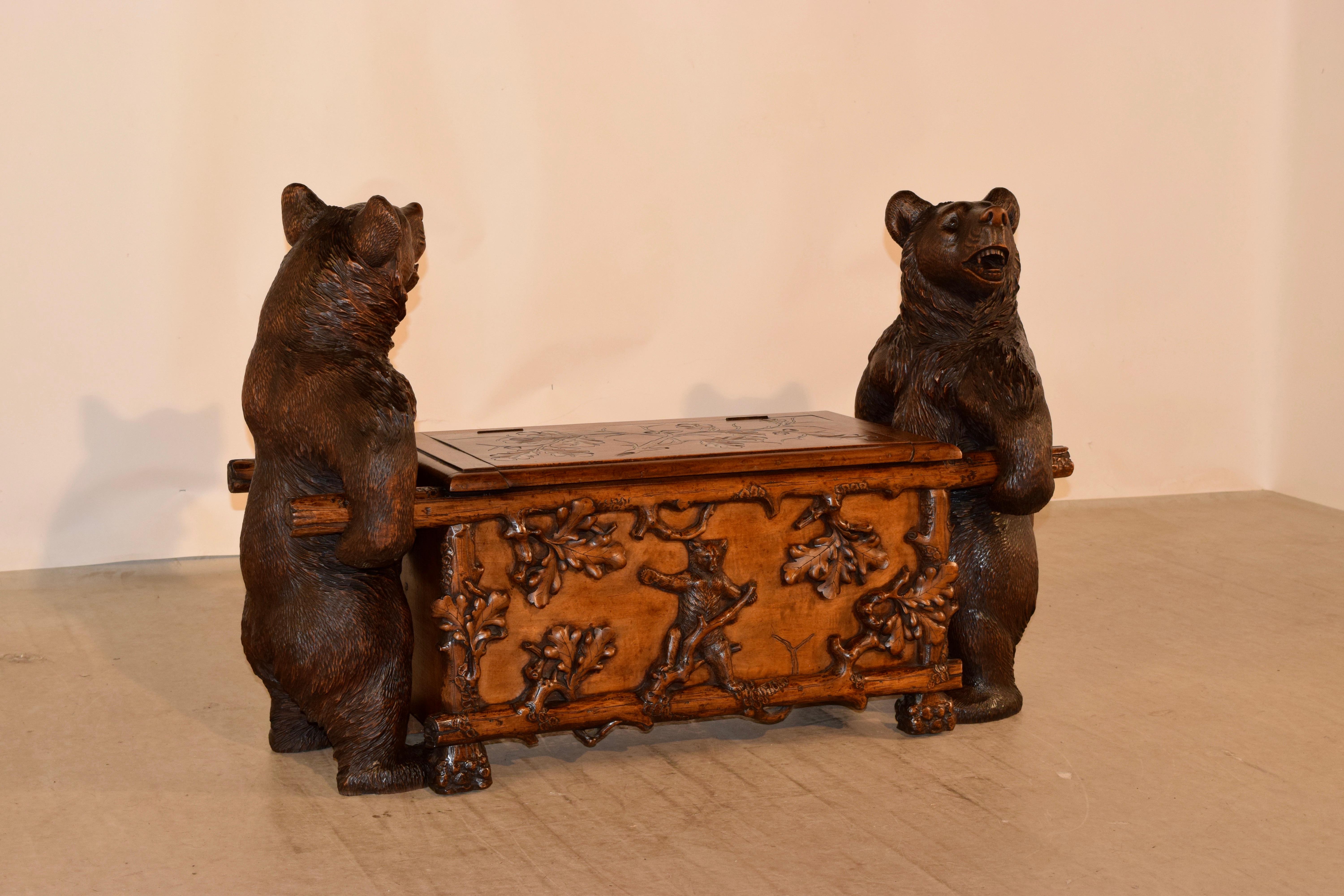 An excellent example of a 19th century Black Forest carved wooden bear bench from Switzerland made from linden wood. The bench having highly detailed hand carved bears at either end standing on their hind legs and holding the handles of the bench