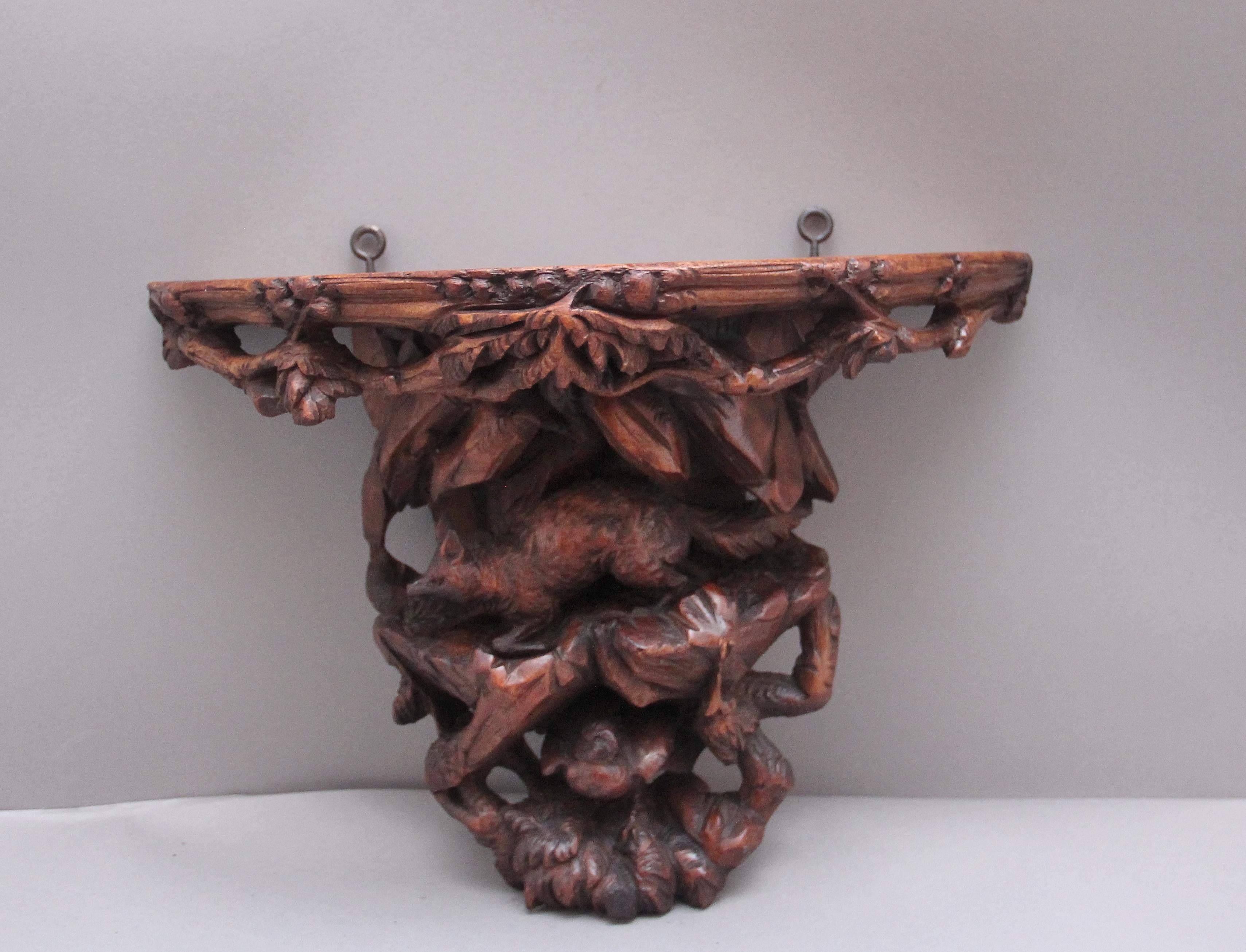19th Century black forest carved wall bracket incorporating a wildlife scene with a fox above a bird amongst various foliage. Circa 1880.