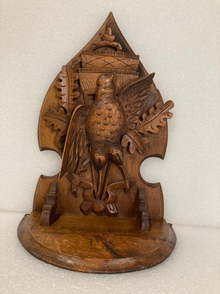 Carved Swiss Black Forest walnut hanging shelf showing a game bird hunt trophy hanging upside down with oak leaves and an acorn. Beautifully carved with a warm honey patina. 
15 inches high 10.75 wide 6 deep.