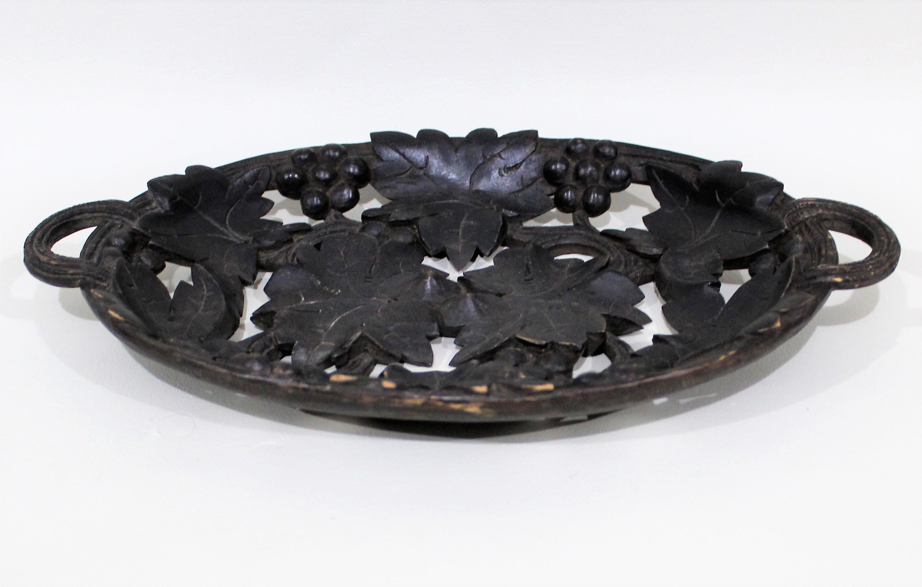 Carved and pierced walnut Black Forest serving bowl/tray with grape and foliate designs.