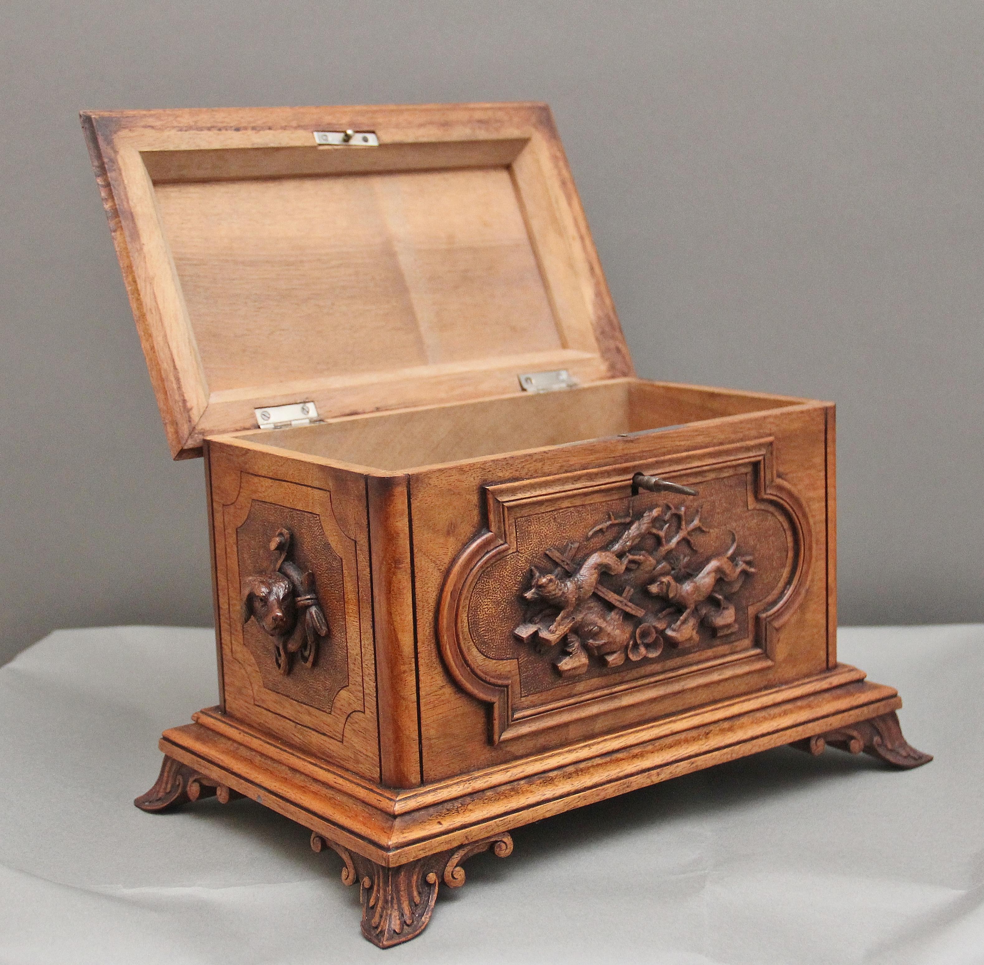 A superb quality 19th Century black forest caved wood casket, having wonderful crisp carving throughout, the hinged top lifting up to reveal a large compartment space, has the original key and lock, the top itself has a multi moulded edge with