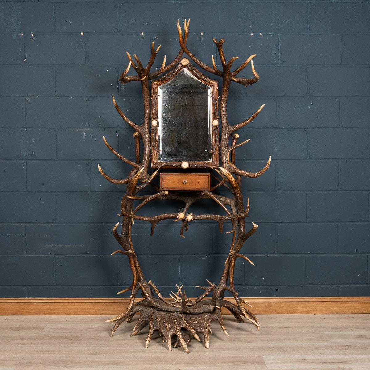 This particular hall stand dates back to the latter part of the 19th century. It has incredible detail, with carved antler horns, as well as using antlers not just for the structure of the hall stand but for detailed decorative elements throughout.