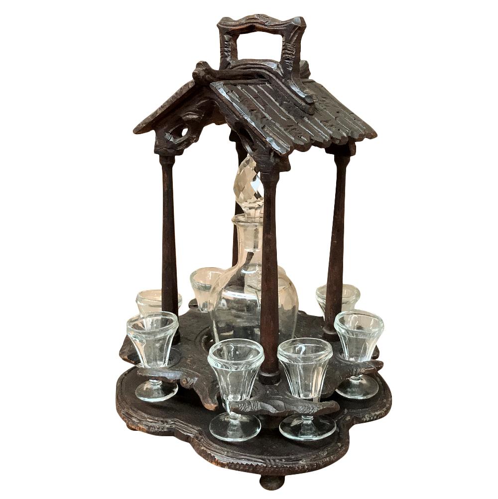 19th Century black forest hand carved liqueur stand with original glass was meant to adorn the library or office, even perhaps the living or drawing room, and provide a top-notch touch of spirits usually partaken after a meal. Hand-scuplted from