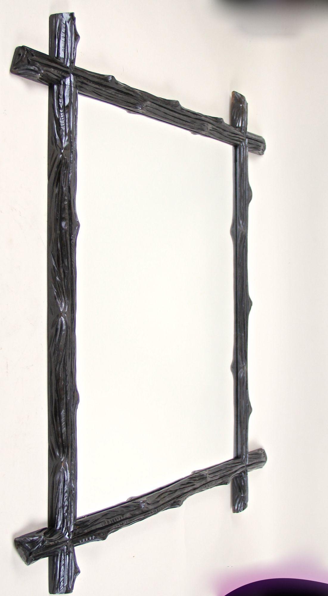 Beautiful, large Black Forest wall mirror from Austria around 1880. This antique rustic wall mirror impresses with a simple but elegant 