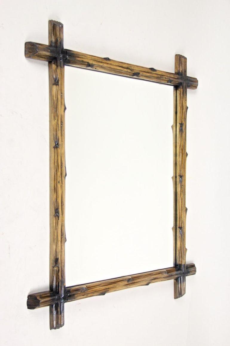 Unusual rustic Black Forest wall mirror out of Austria. From circa 1890 comes this lovely hand carved Black Forest wall mirror with a simple but elegant design, created out of basswood and showing the typical 