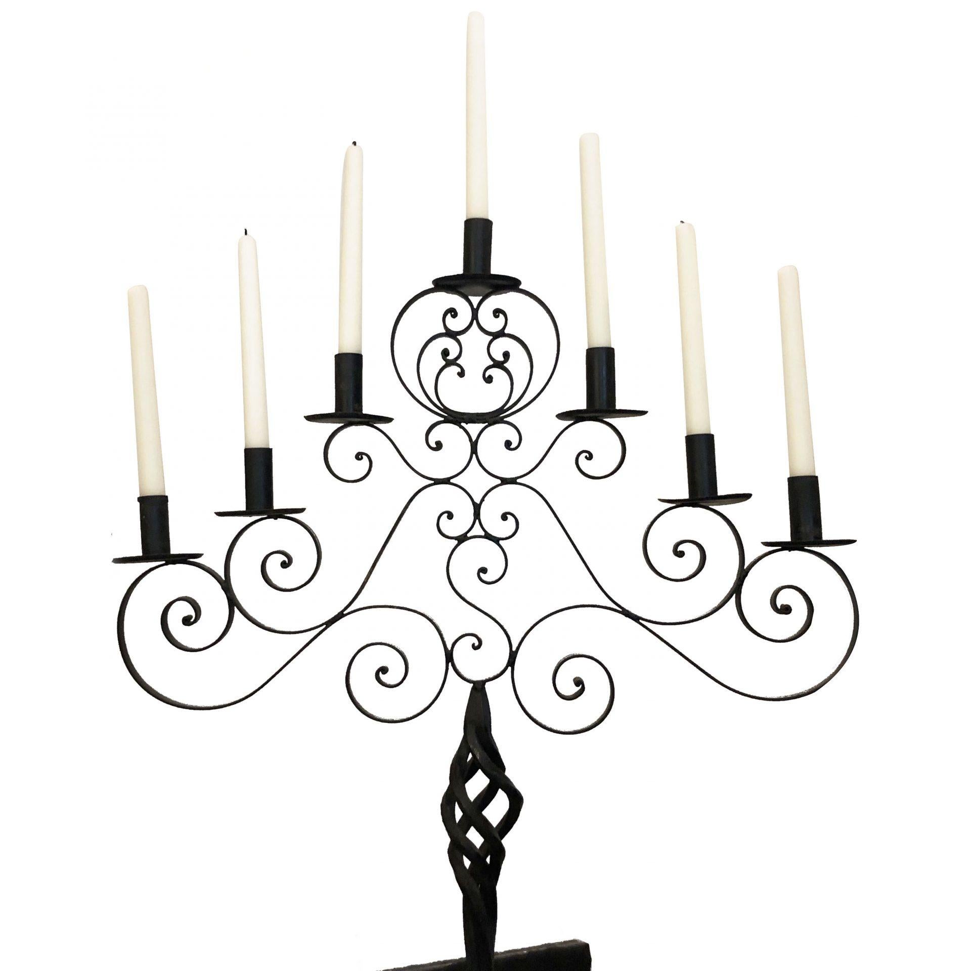 A black antique, late 19th century French floor candle holder, candelabra hand crafted in very ornate fer forge work with wrought iron scrolls and seven candle holders, in good condition. Wear consistent with age and use. circa 1890, France.