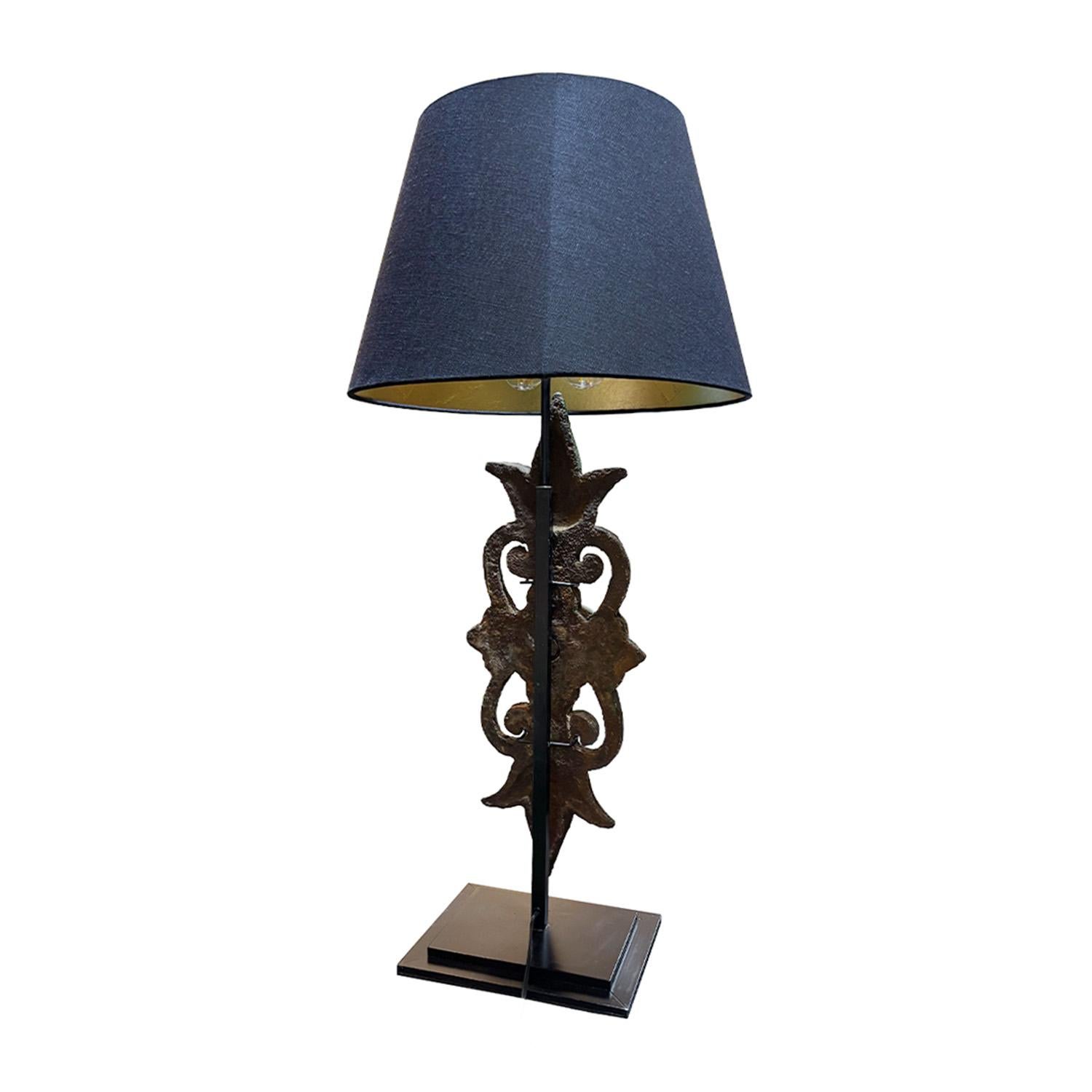 An antique French tall table lamp with a green iron ornament which is supported, halted by a black metal base, in good condition. The sculptural décor light is composed with a new black shade, featuring a two light socket. The wires have been