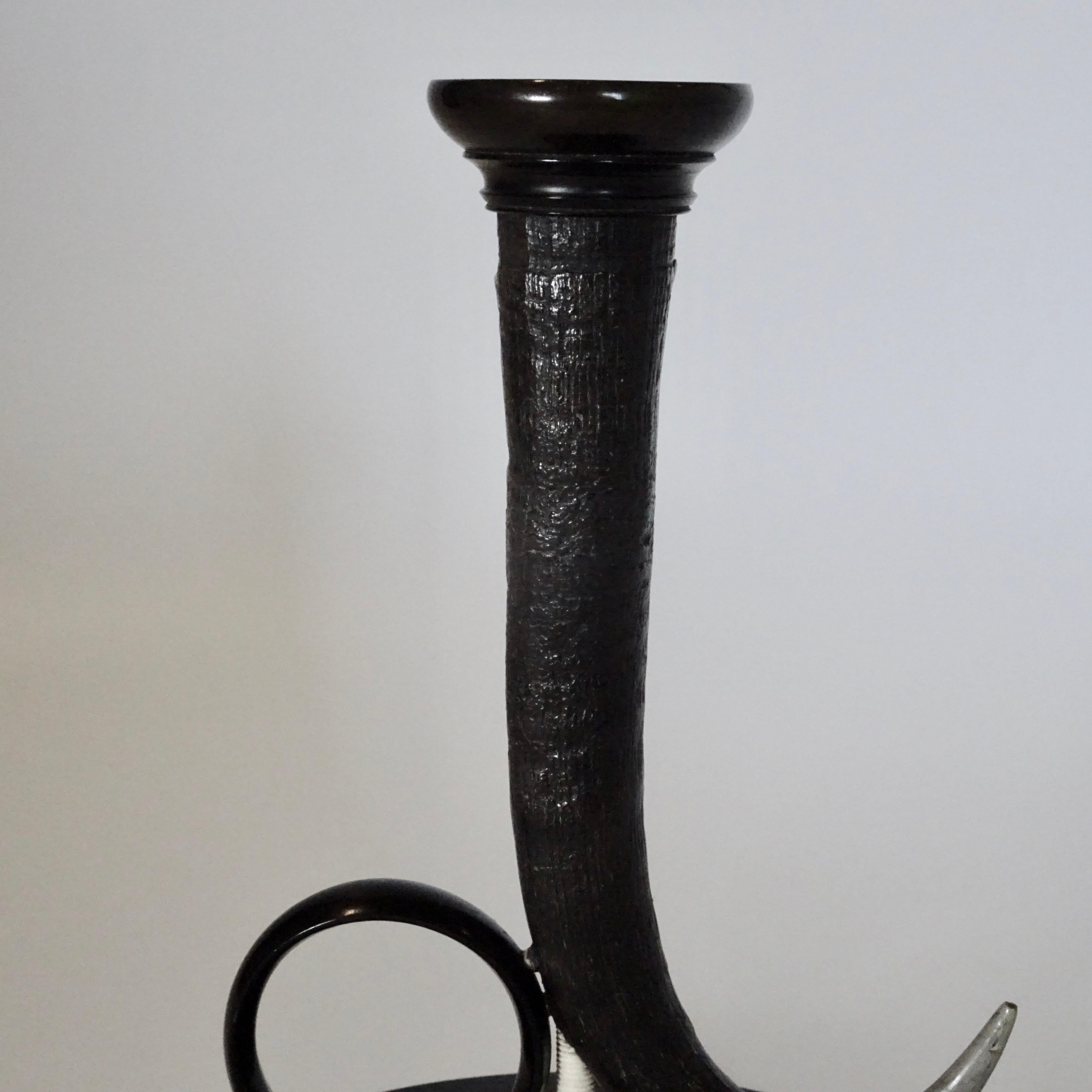 19th century black horn candlestick on black wooden base.
