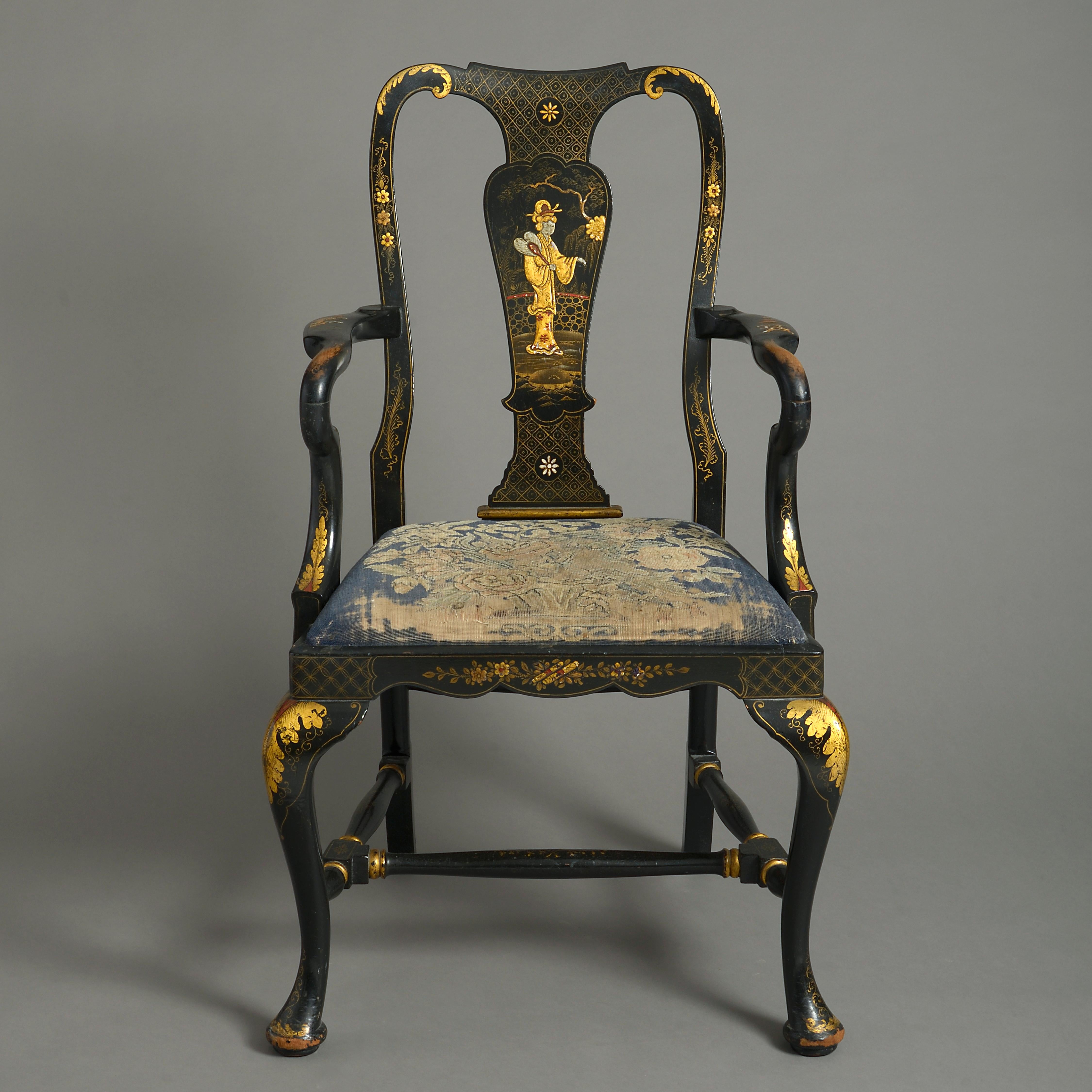 A late 19th century black japanned and gilded open armchair in the Queen Anne manner, having a shaped splat back, decorated throughout with chinoiserie, an upholstered seat and all raised upon cabriole legs terminating in pad feet.