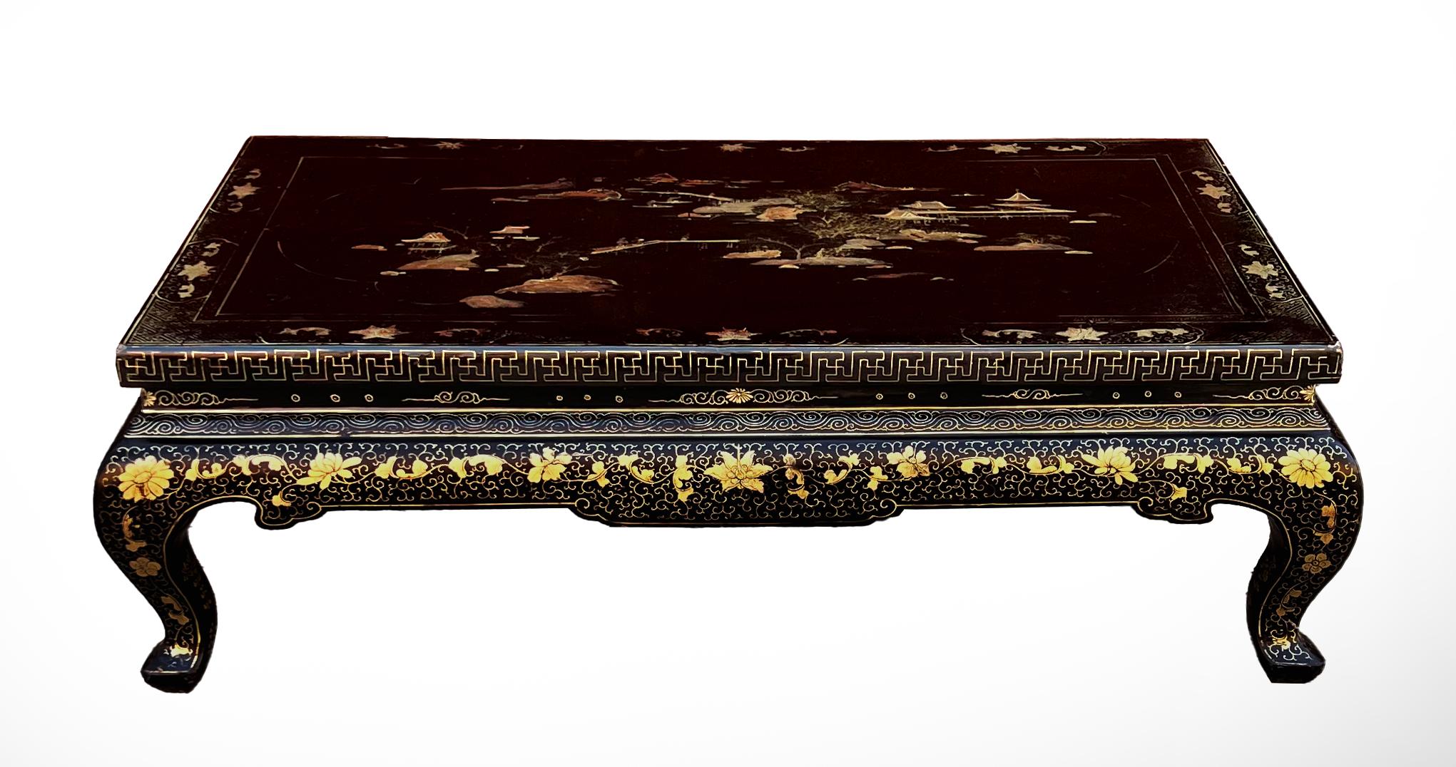 A stunning black lacquer and gilt Chinese low table. The top of the table exhibits extremely fine painted landscape scenes while the frieze and legs are decorated with gold meanders and floral motifs.