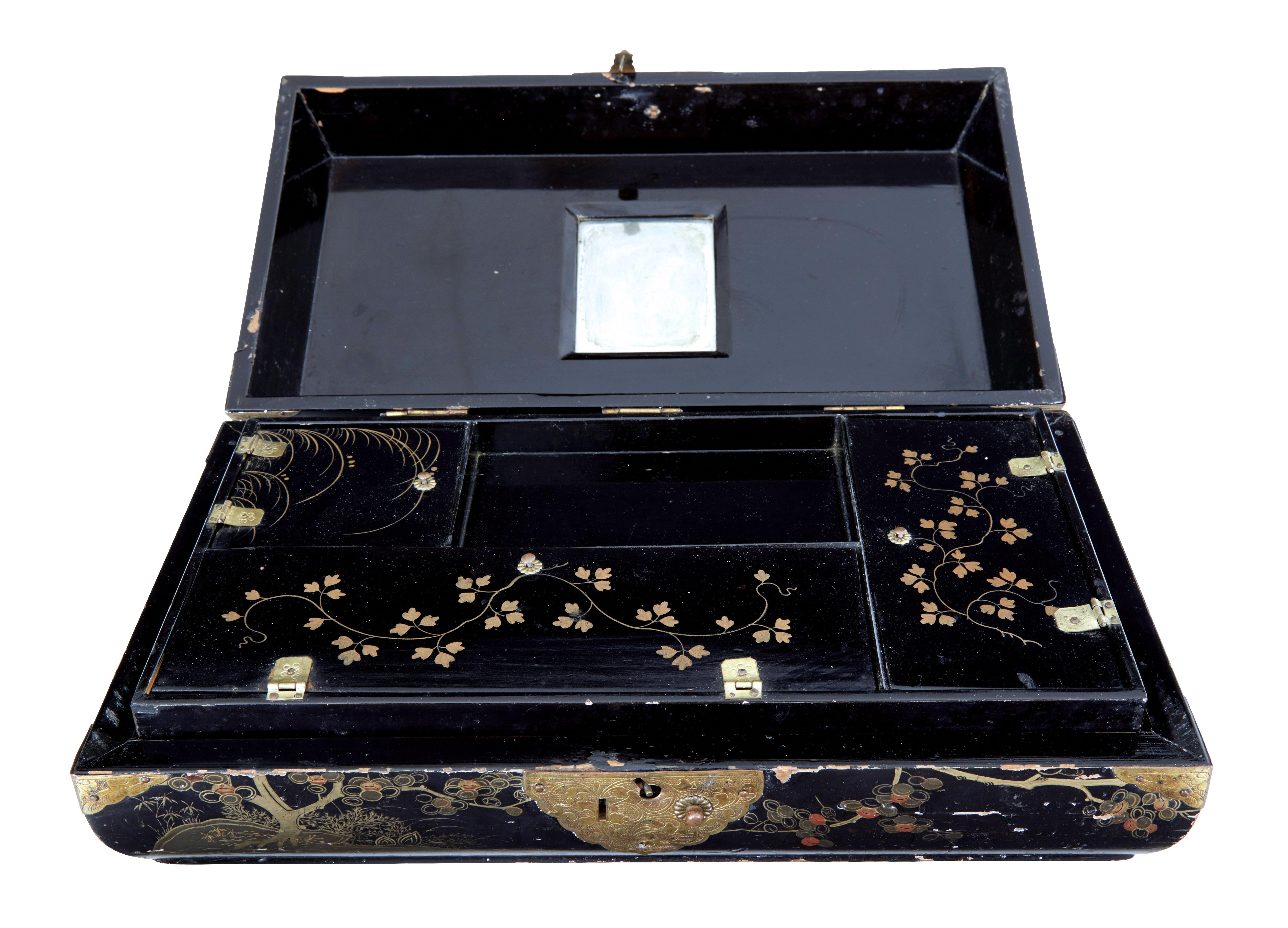 19th century Chinese black lacquered jewellery box circa 1860.

Good quality shaped Chinese jewellery box with overstuffed top cushion. Hand painted in gold leaf on all surfaces, with the main feature being on the front. Original decorative metal