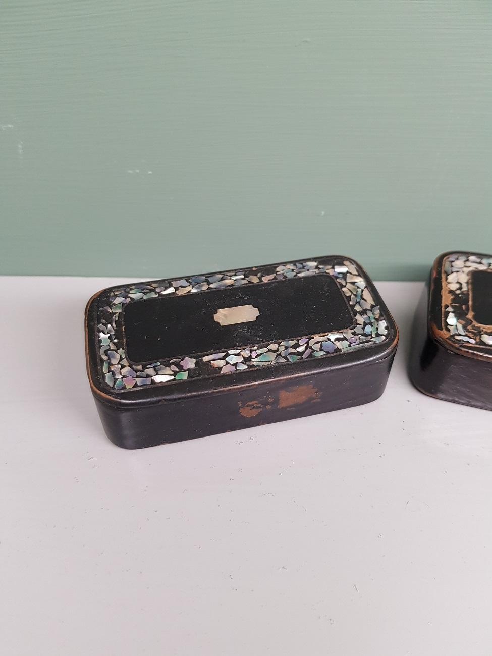 2 old black lacquered snuff boxes inlaid with mother of pearl, from the 19th century.

The measurements are,
Depth 4 cm/ 1.5 inch.
Width 7.5 cm/ 2.9 inch.
Height 2.5 cm/ 0.9 inch.